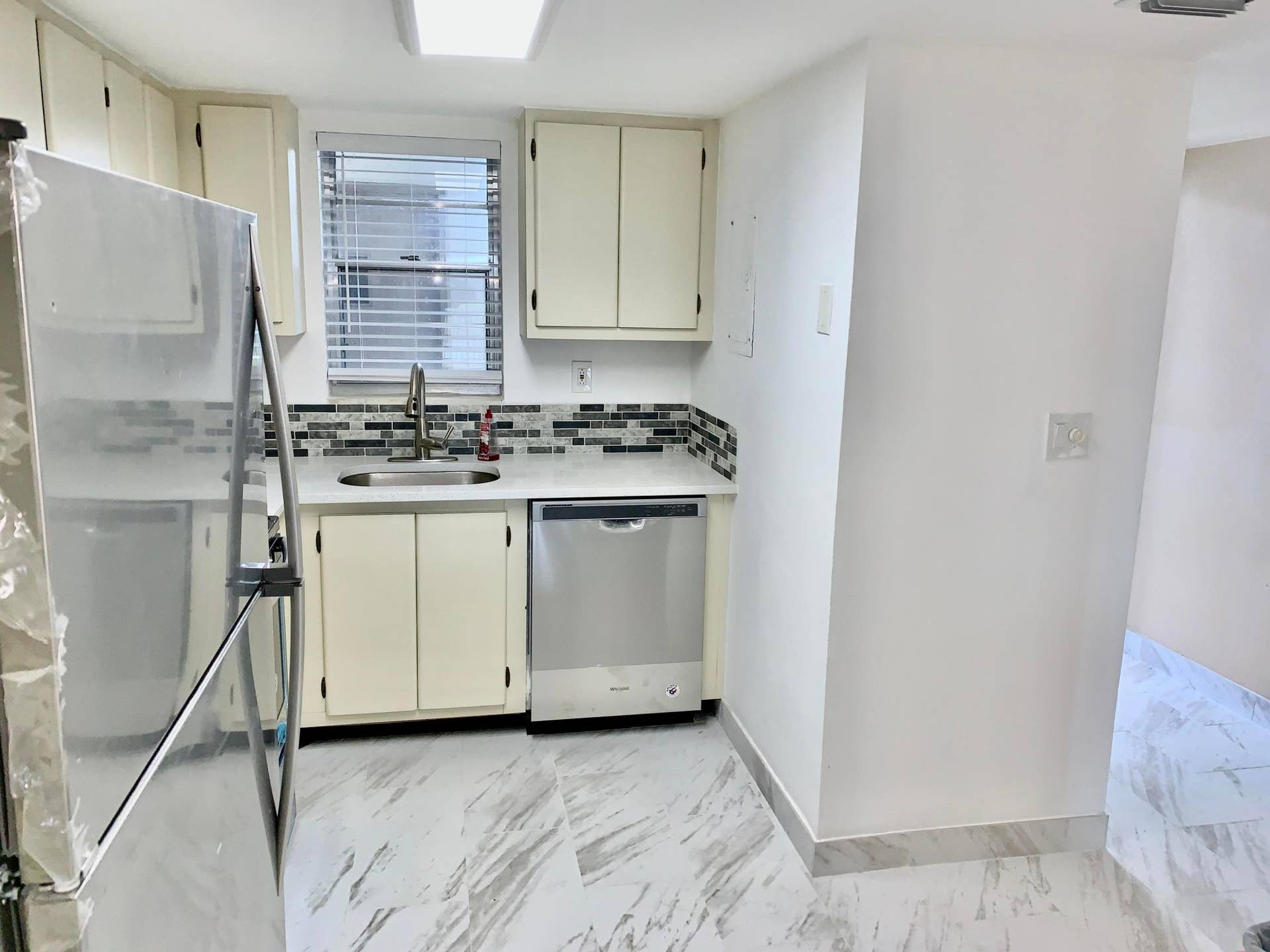 3100 W Rolling Hills Circle, #309, Davie, Davie, FL 33328 Kitchen featuring white cabinetry, a stainless steel refrigerator, and a coordinating stainless steel dishwasher