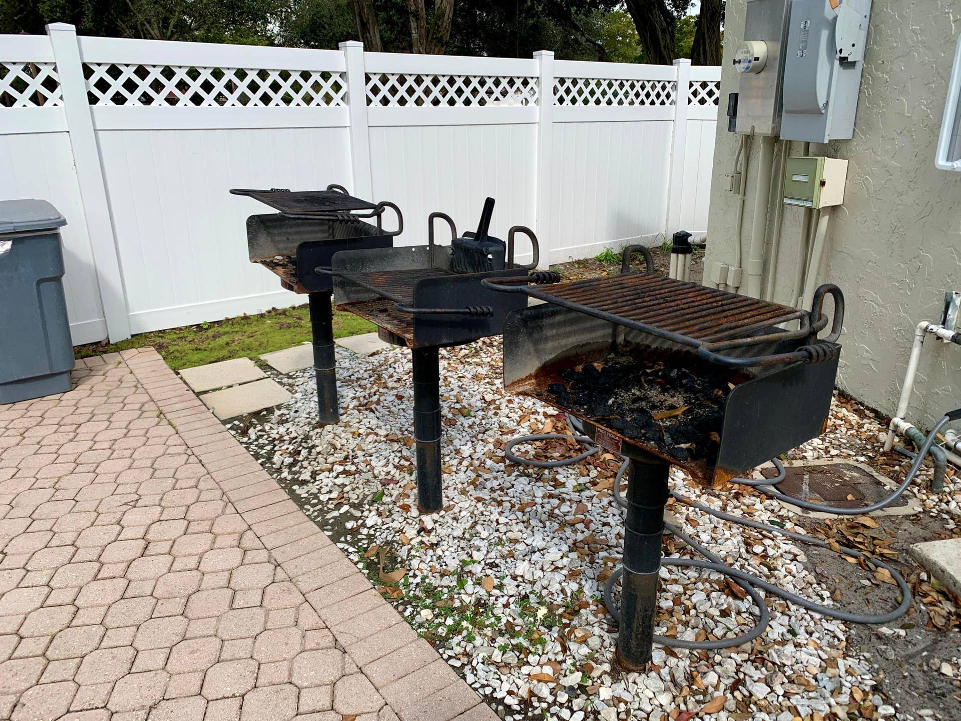 3100 W Rolling Hills Circle, #309, Davie, Davie, FL 33328 Paved patio area featuring multiple built-in charcoal grills on a gravel base
