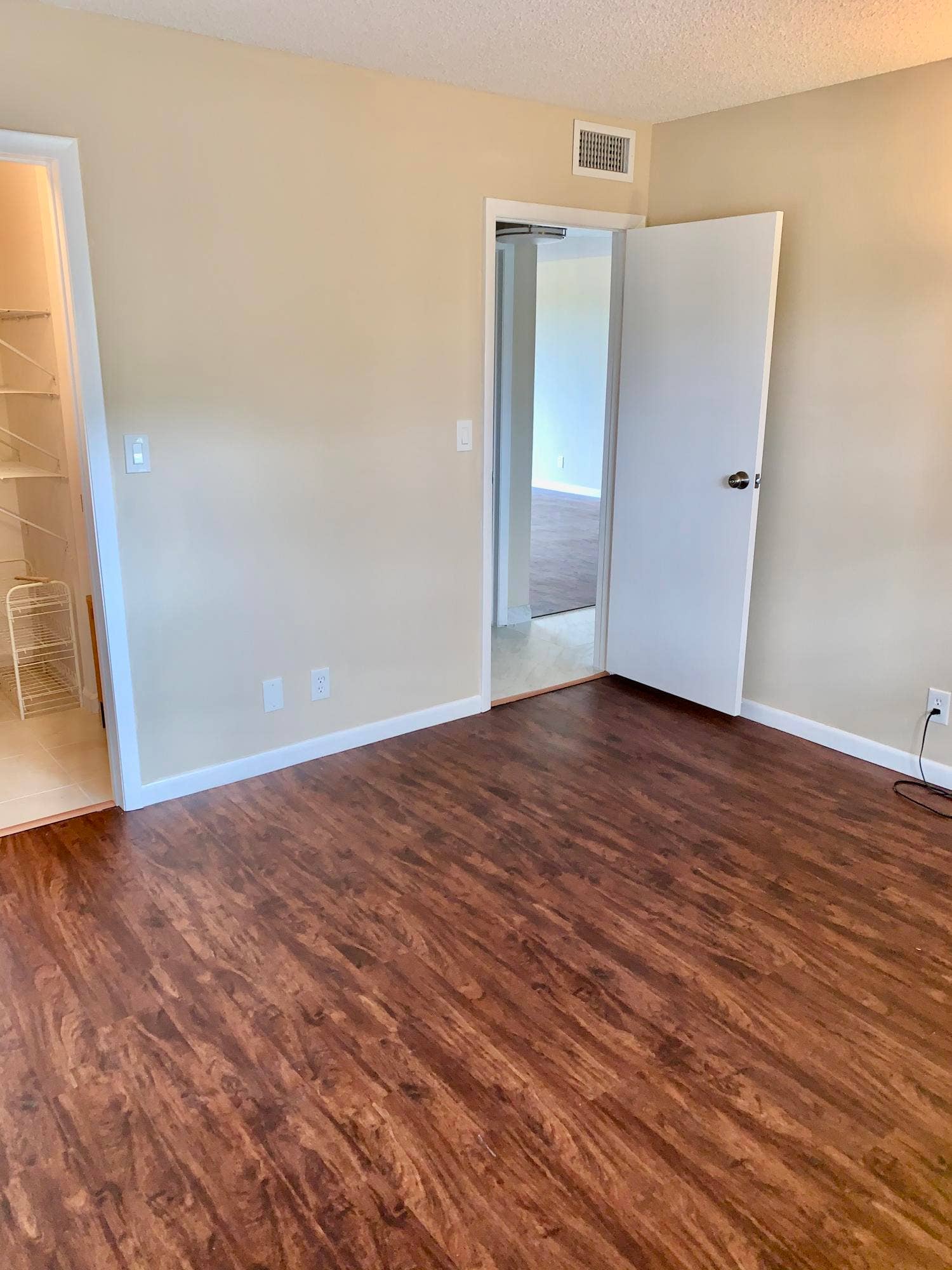 3100 W Rolling Hills Circle, #309, Davie, Davie, FL 33328 Wood-finish flooring throughout, featuring a neutral wall palette, white baseboards, and a built-in closet system