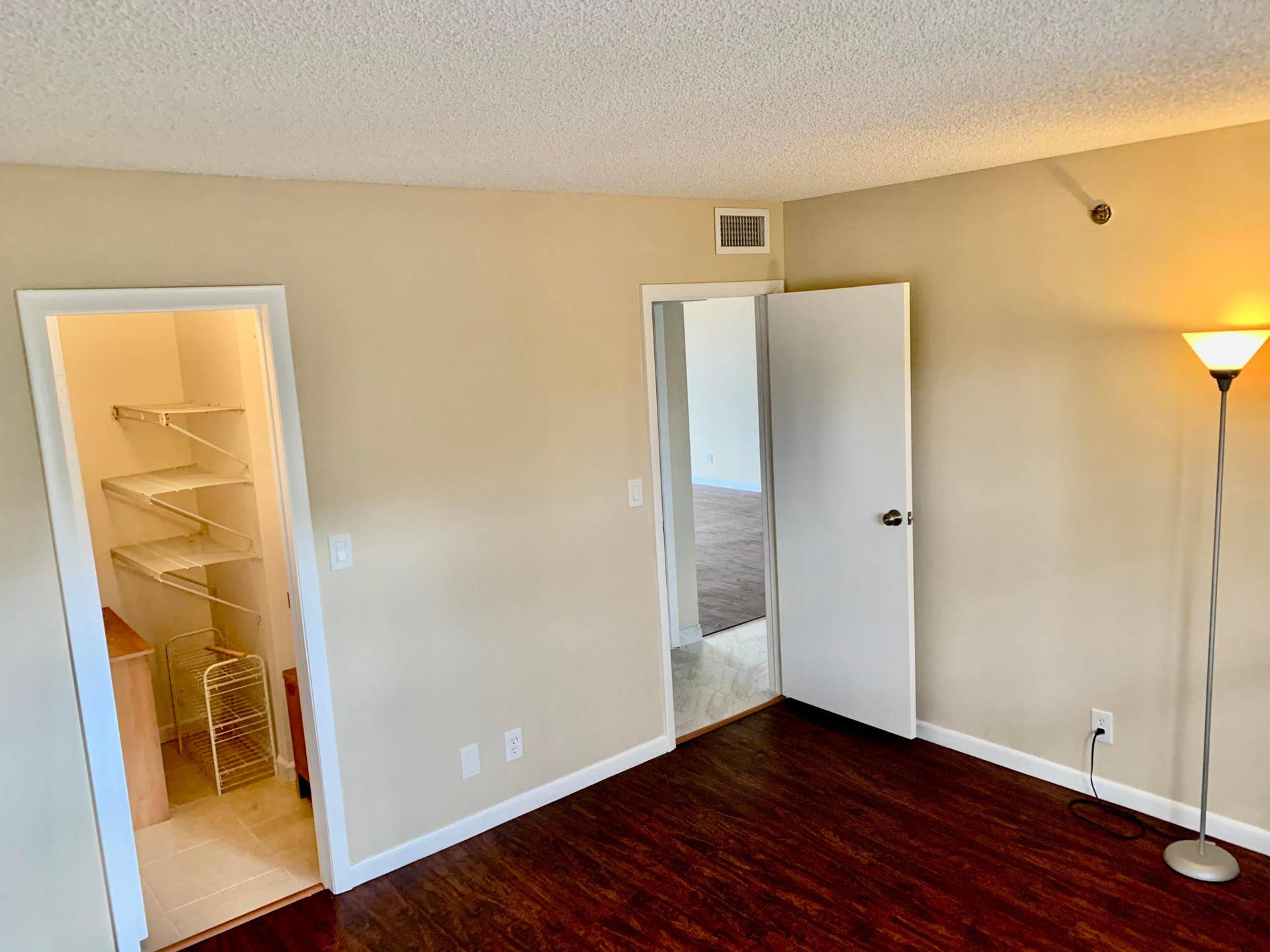 3100 W Rolling Hills Circle, #309, Davie, Davie, FL 33328 Spacious room featuring dark wood-finish flooring, light neutral-toned walls, and white baseboards
