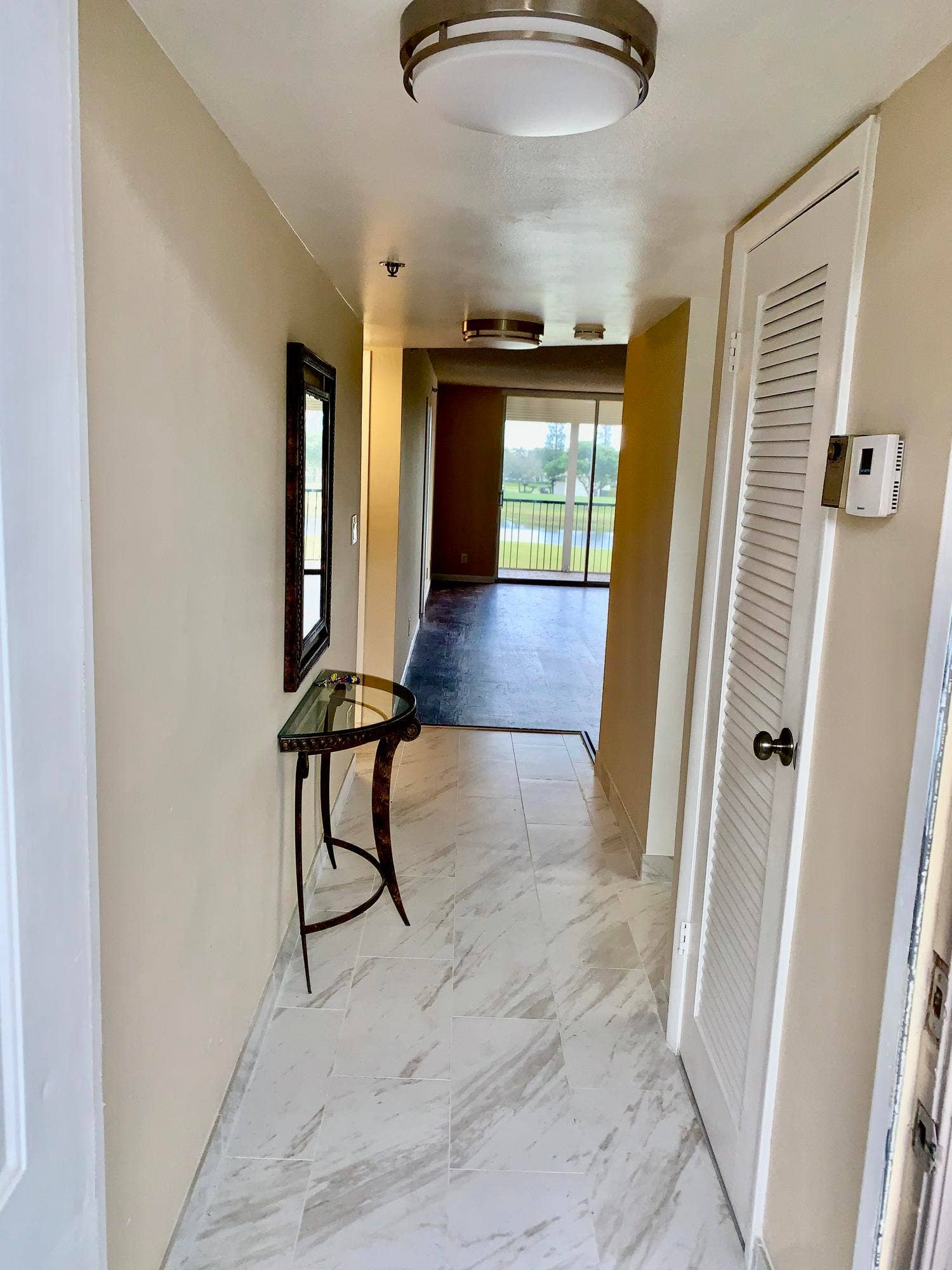 3100 W Rolling Hills Circle, #309, Davie, Davie, FL 33328 Entryway with light-toned tiled flooring, featuring a flush-mount ceiling light
