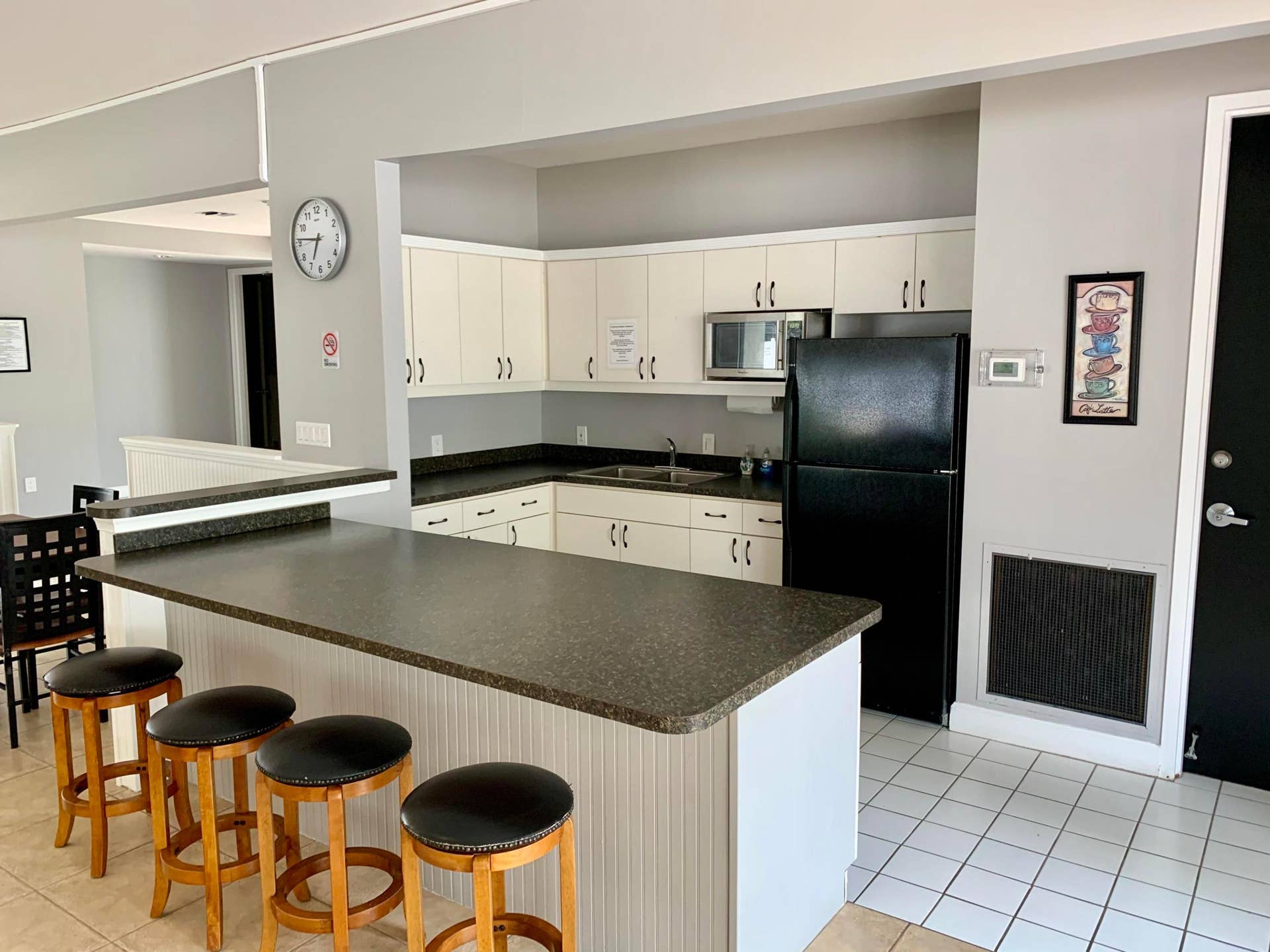 3100 W Rolling Hills Circle, #309, Davie, Davie, FL 33328 Kitchen area featuring white cabinetry, dark countertops, a black refrigerator, and a built-in microwave
