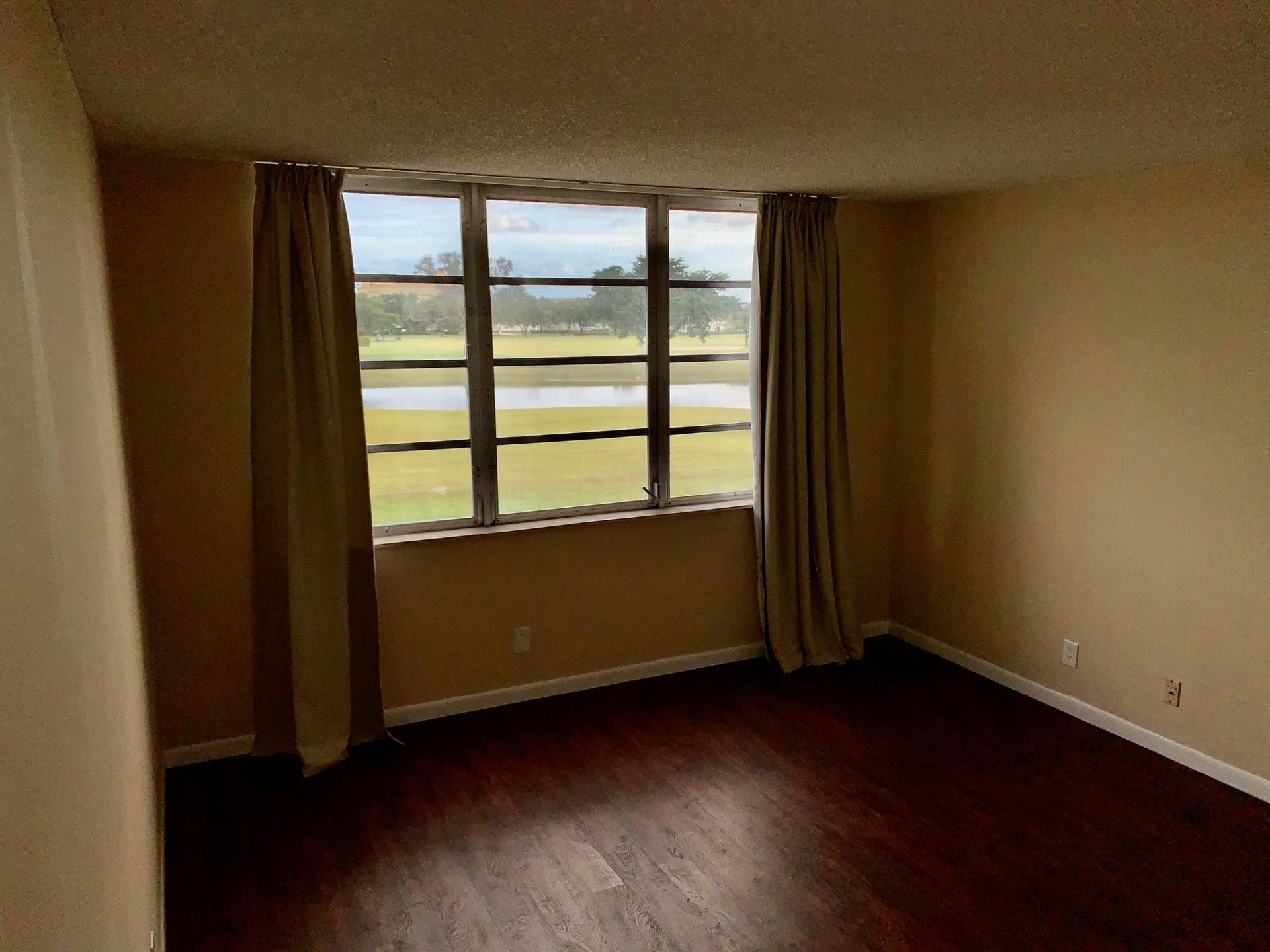 3100 W Rolling Hills Circle, #309, Davie, Davie, FL 33328 Room featuring wood-finish flooring, neutral wall tones, and a large window with a multi-pane design