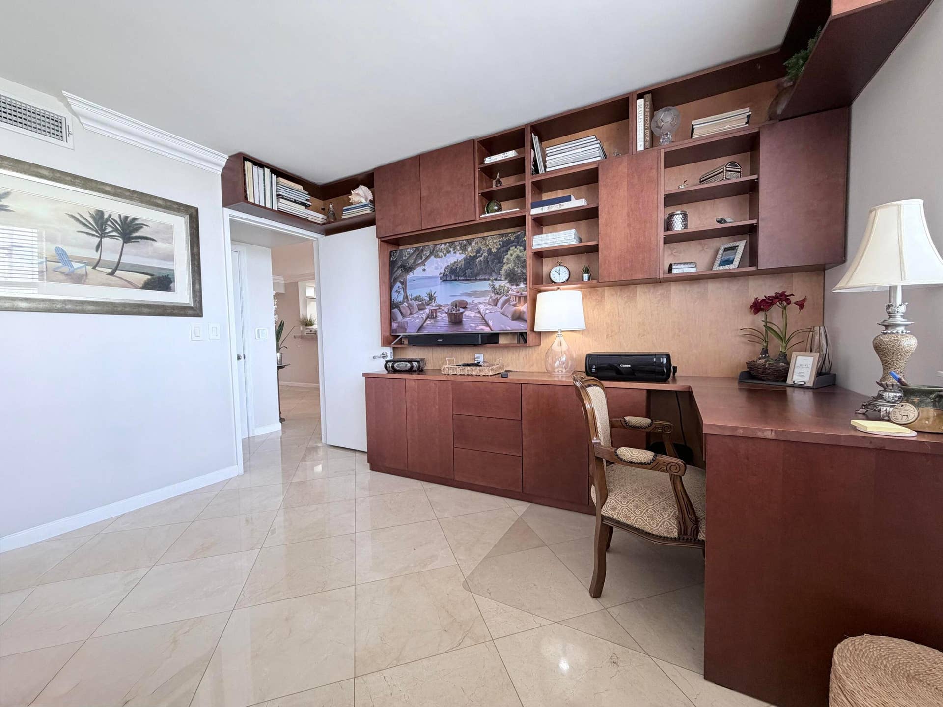 bedroom with wall mounted tv and wall unit/w desk