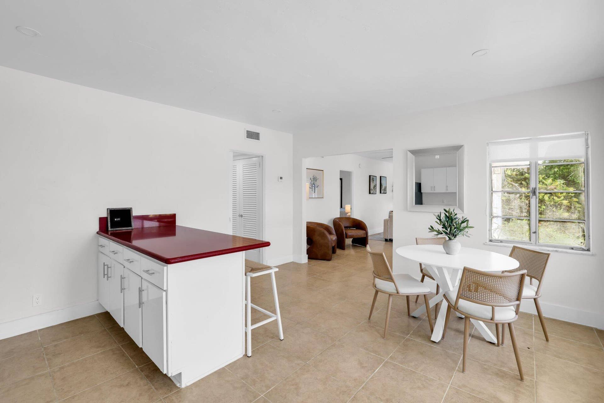 320 Inlet Way, #4, Palm Beach Shores, Palm Beach Shores, FL 33404 Open concept living space featuring neutral tile flooring, white walls, and a window with natural light