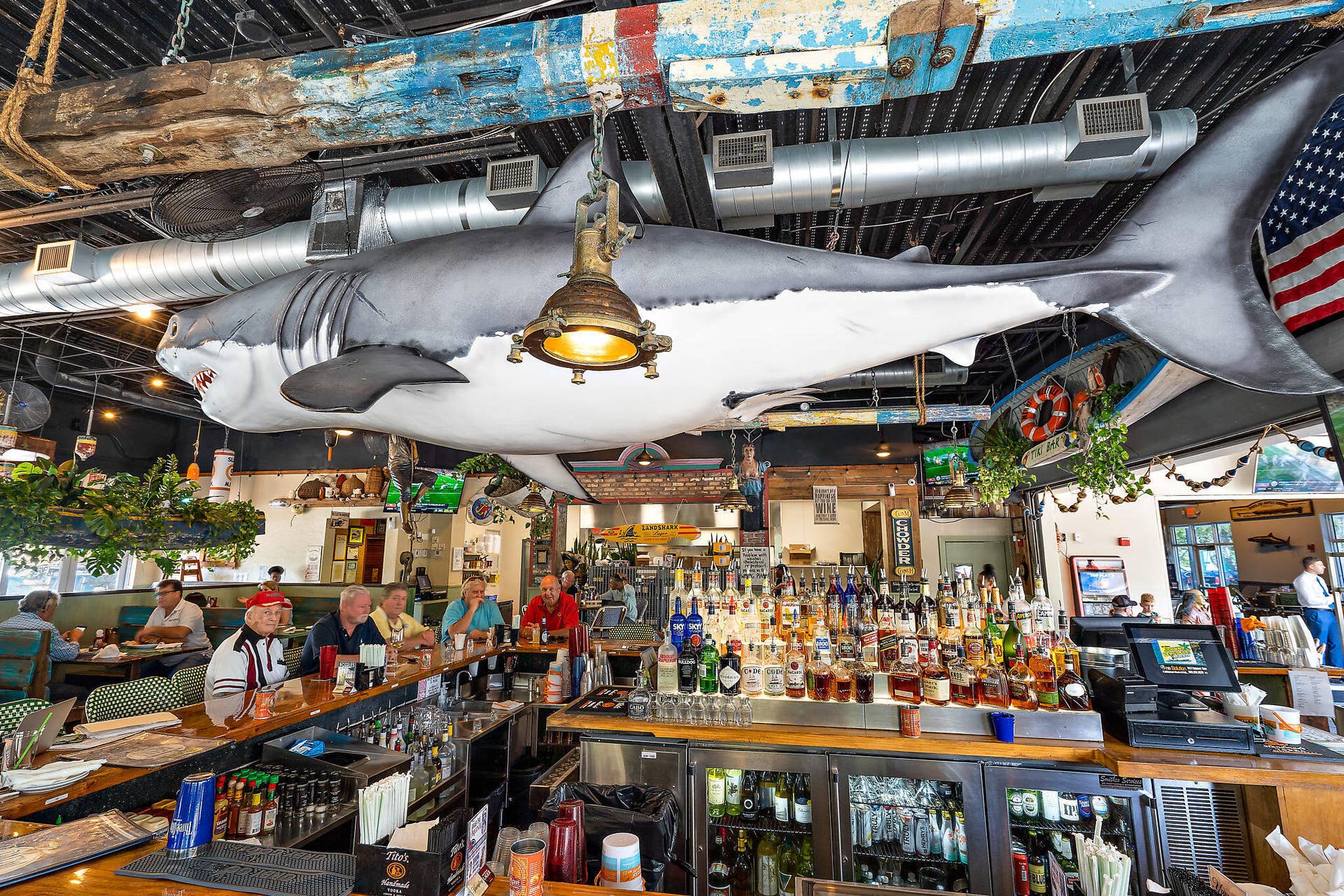 320 Inlet Way, #4, Palm Beach Shores, Palm Beach Shores, FL 33404 Spacious bar area featuring a large shark sculpture, ample seating, a full-service bar, exposed ductwork, and decorative nautical elements