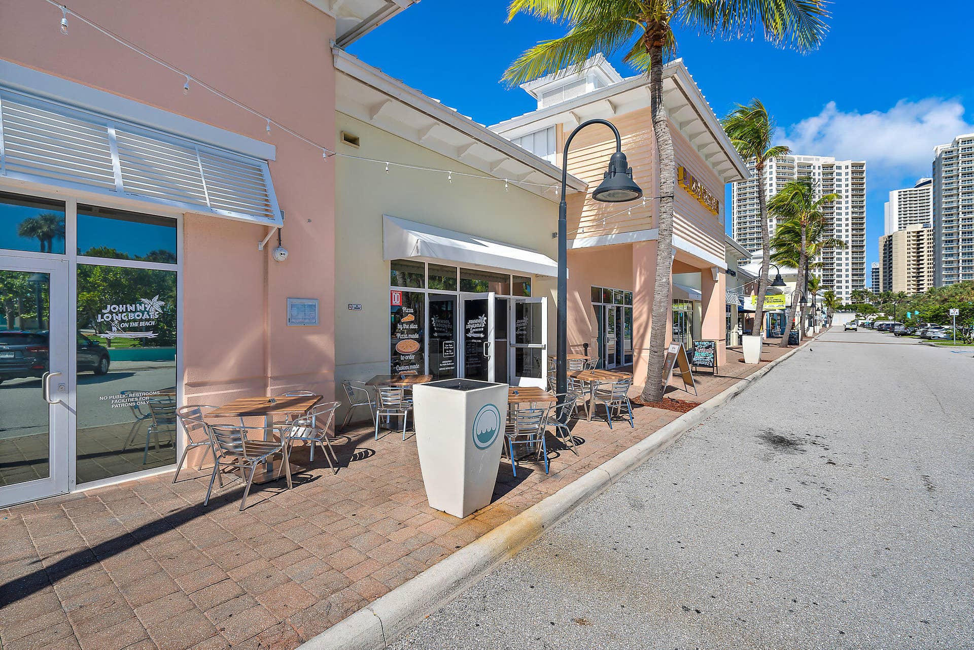 320 Inlet Way, #4, Palm Beach Shores, Palm Beach Shores, FL 33404 Street-level commercial storefronts featuring outdoor seating areas and a paver brick sidewalk