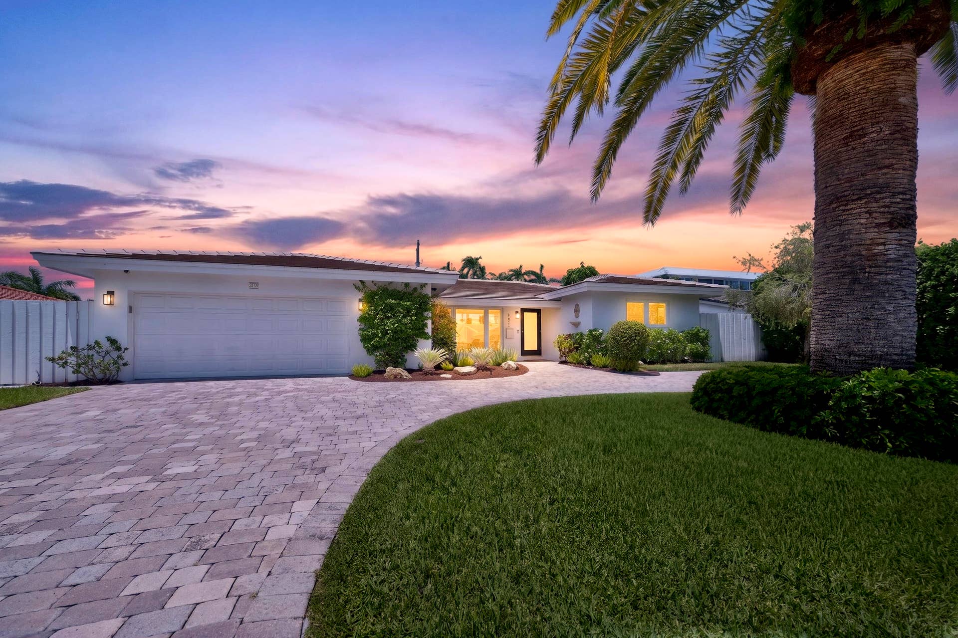 Contemporary single-story residence with a paver driveway
