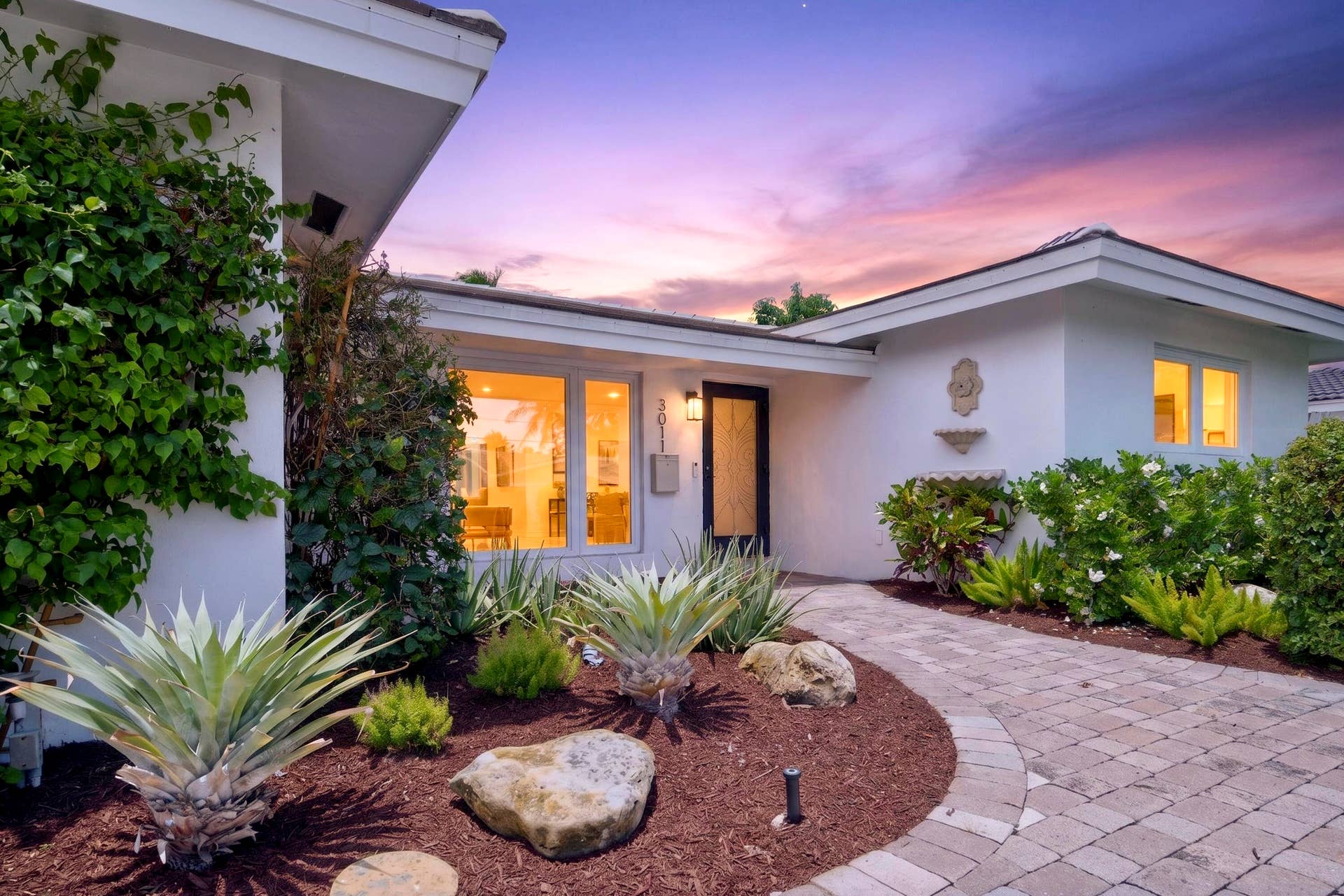 White stucco exterior with a tiled roofline