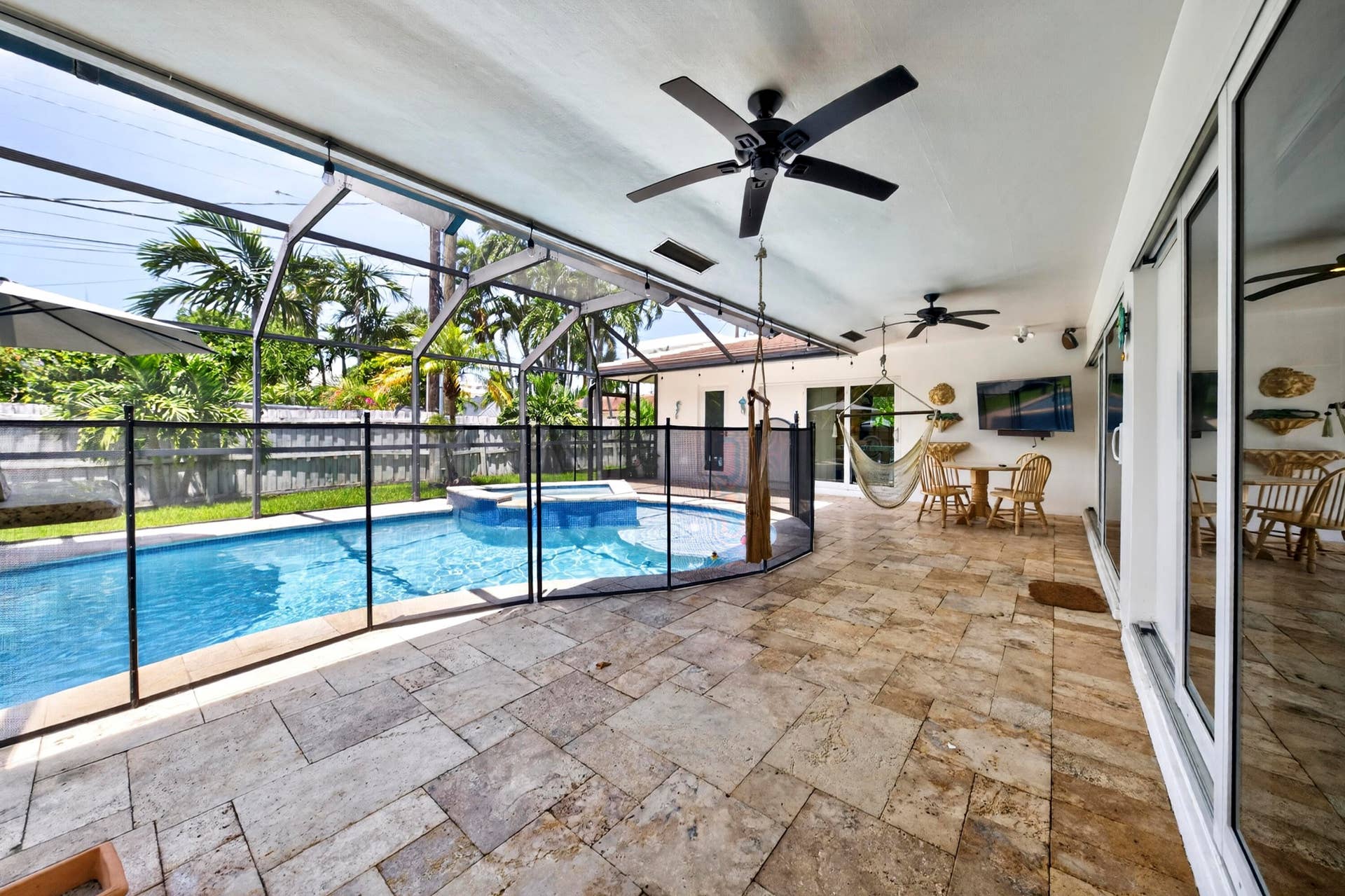 Screened patio with stone tile flooring