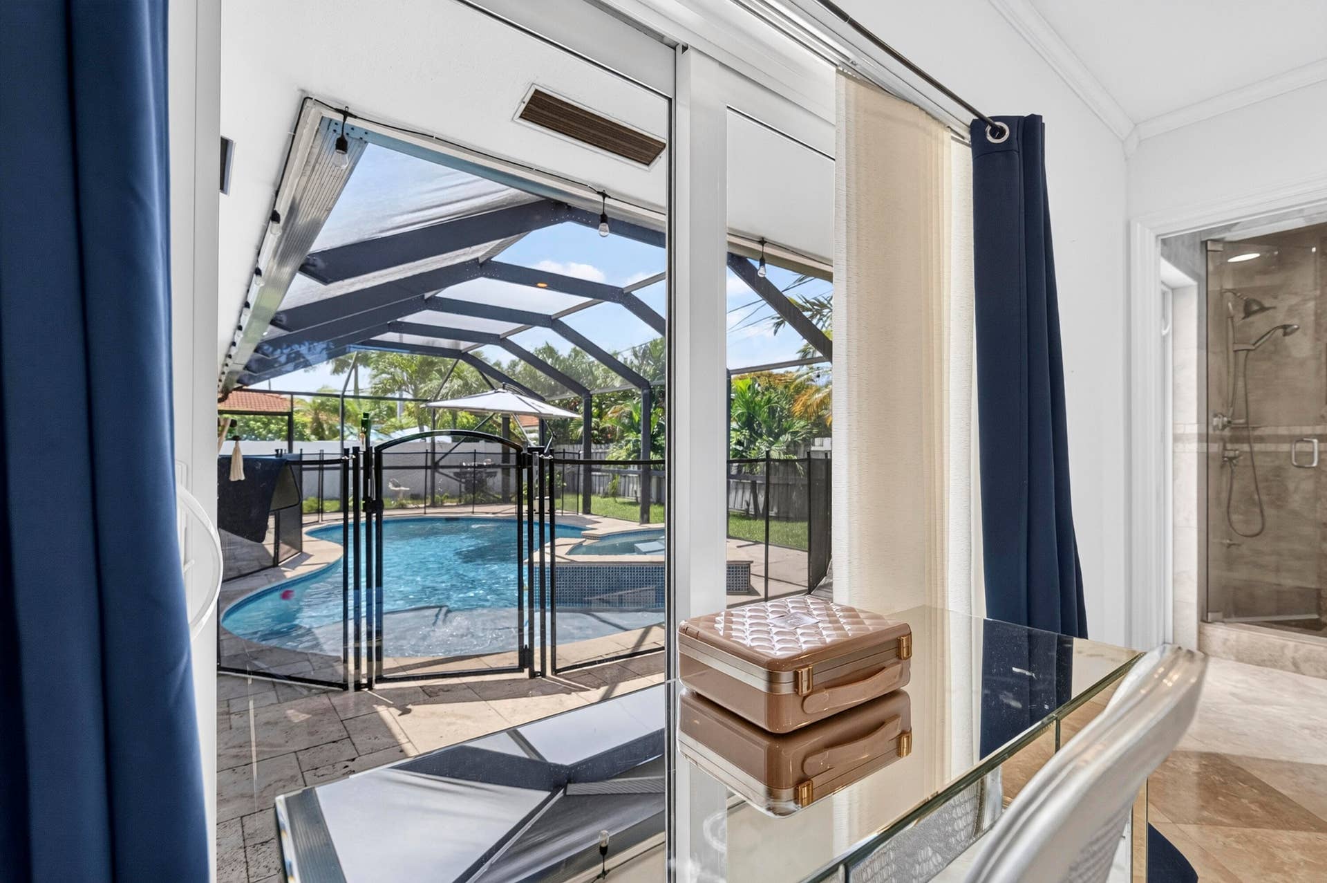 Sliding glass doors opening to a screened lanai with a pool and built-in spa