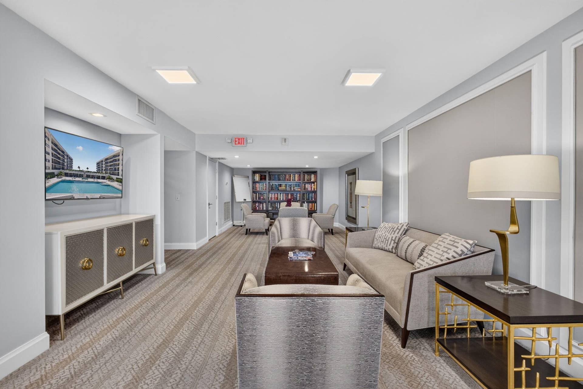 3140 S Ocean Boulevard, #101 S, Palm Beach, FL 33480 Lounge area featuring patterned carpeting, recessed ceiling lighting, decorative wall molding, and a built-in media niche with cabinetry