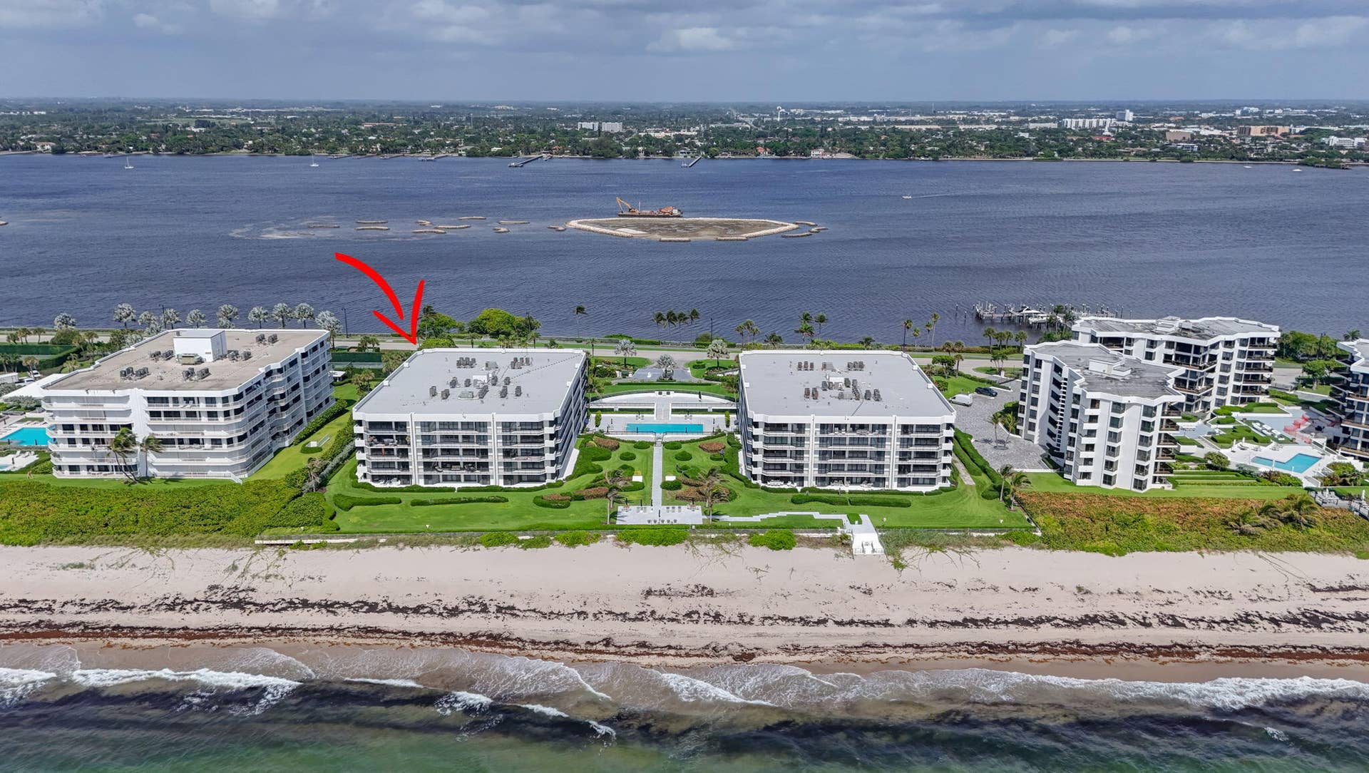 3140 S Ocean Boulevard, #101 S, Palm Beach, FL 33480 Beachfront residential building featuring multiple private balconies, landscaped grounds, a community pool, and direct beach access