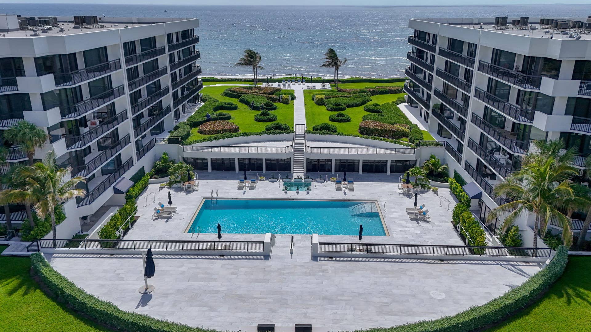 3140 S Ocean Boulevard, #101 S, Palm Beach, FL 33480 Resort-style complex featuring two multi-story buildings, a central swimming pool, and landscaped green spaces