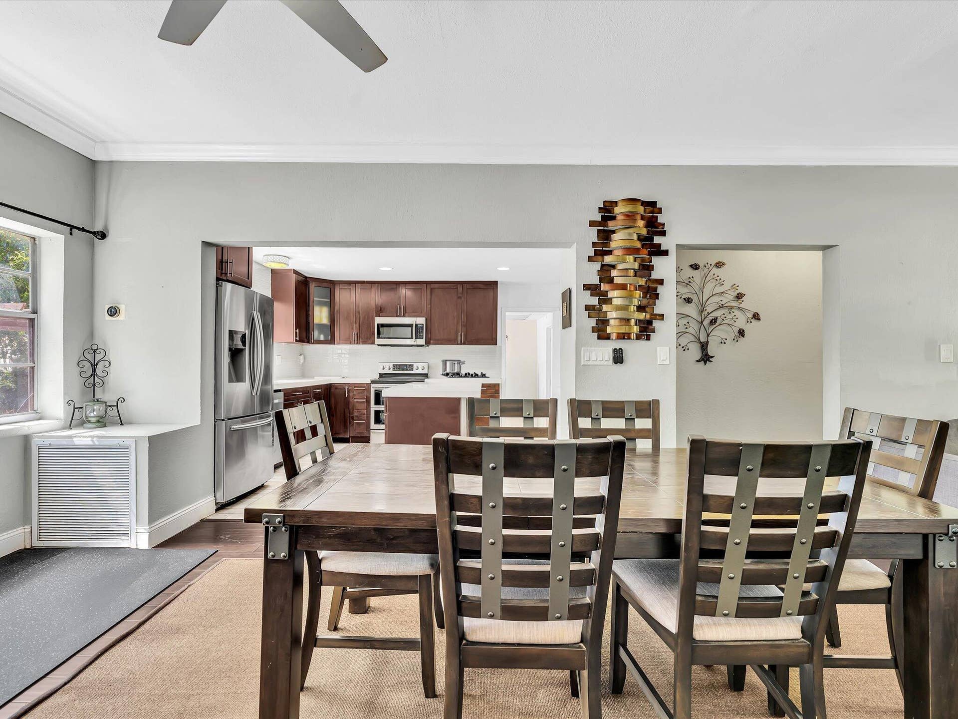 Dining area with light gray walls and crown molding