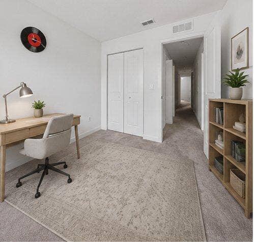 Light-toned wall-to-wall carpeting throughout this versatile room