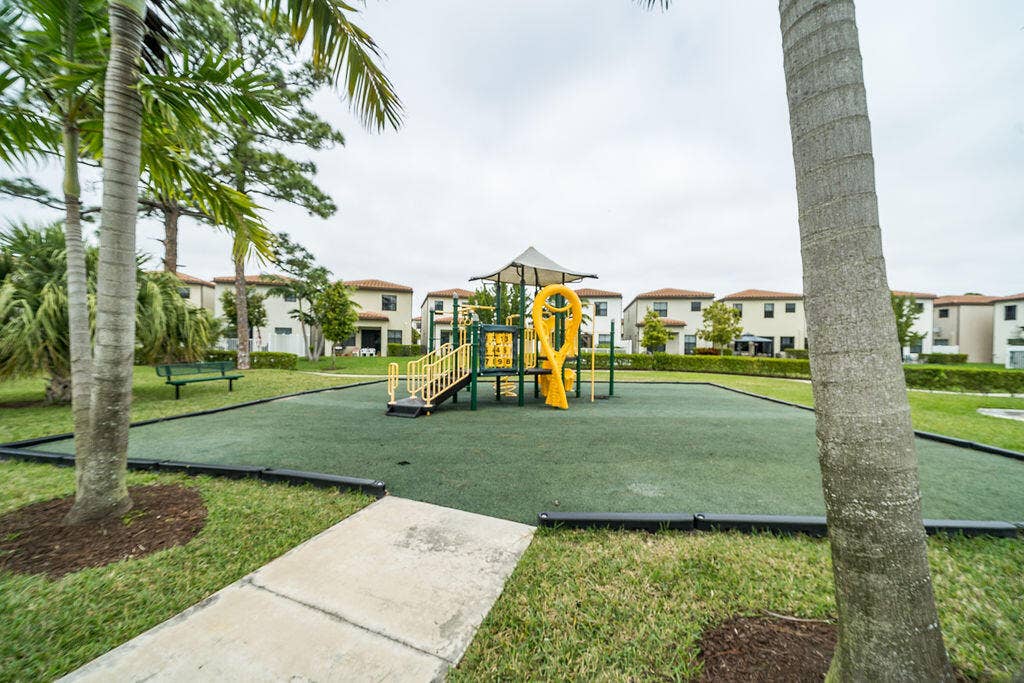 Expansive recreation area featuring a playground with slides and climbing elements