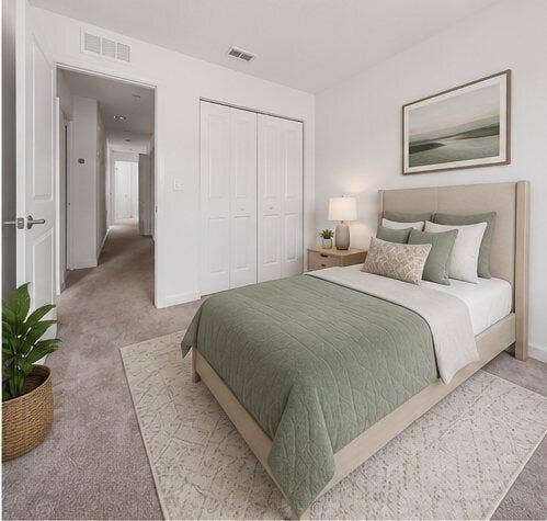 Bedroom featuring neutral carpeting, white walls, and a closet