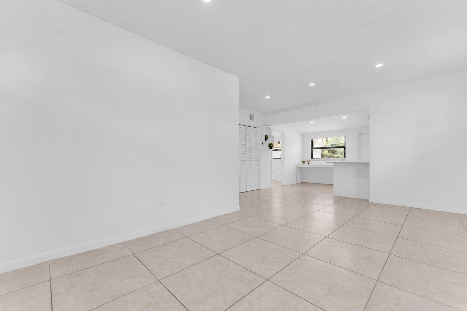 Neutral tile flooring extends through the space