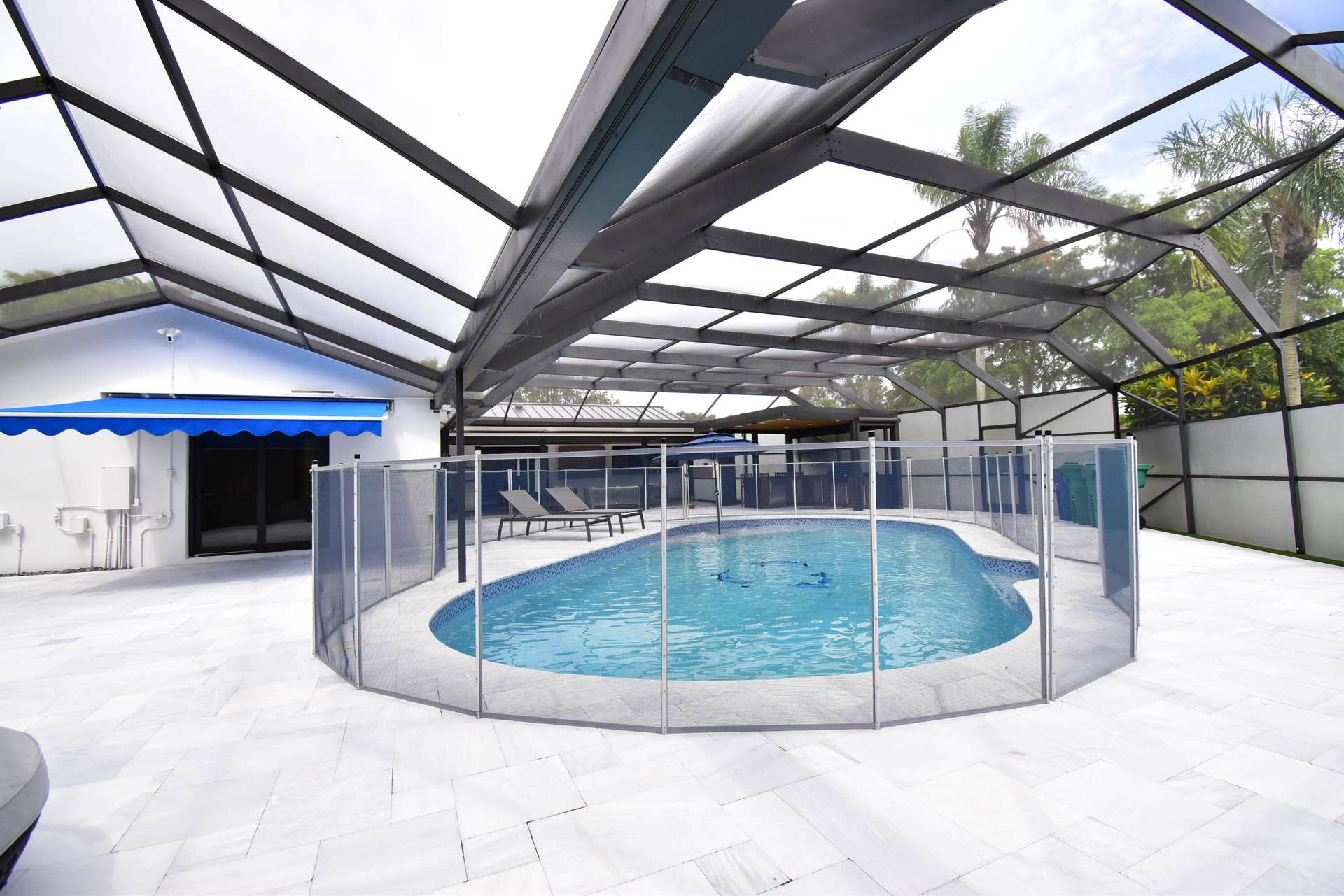 5061 SW 87TH Terrace, Cooper City, FL 33328 Screen-enclosed pool area featuring a freeform swimming pool with a surrounding safety fence