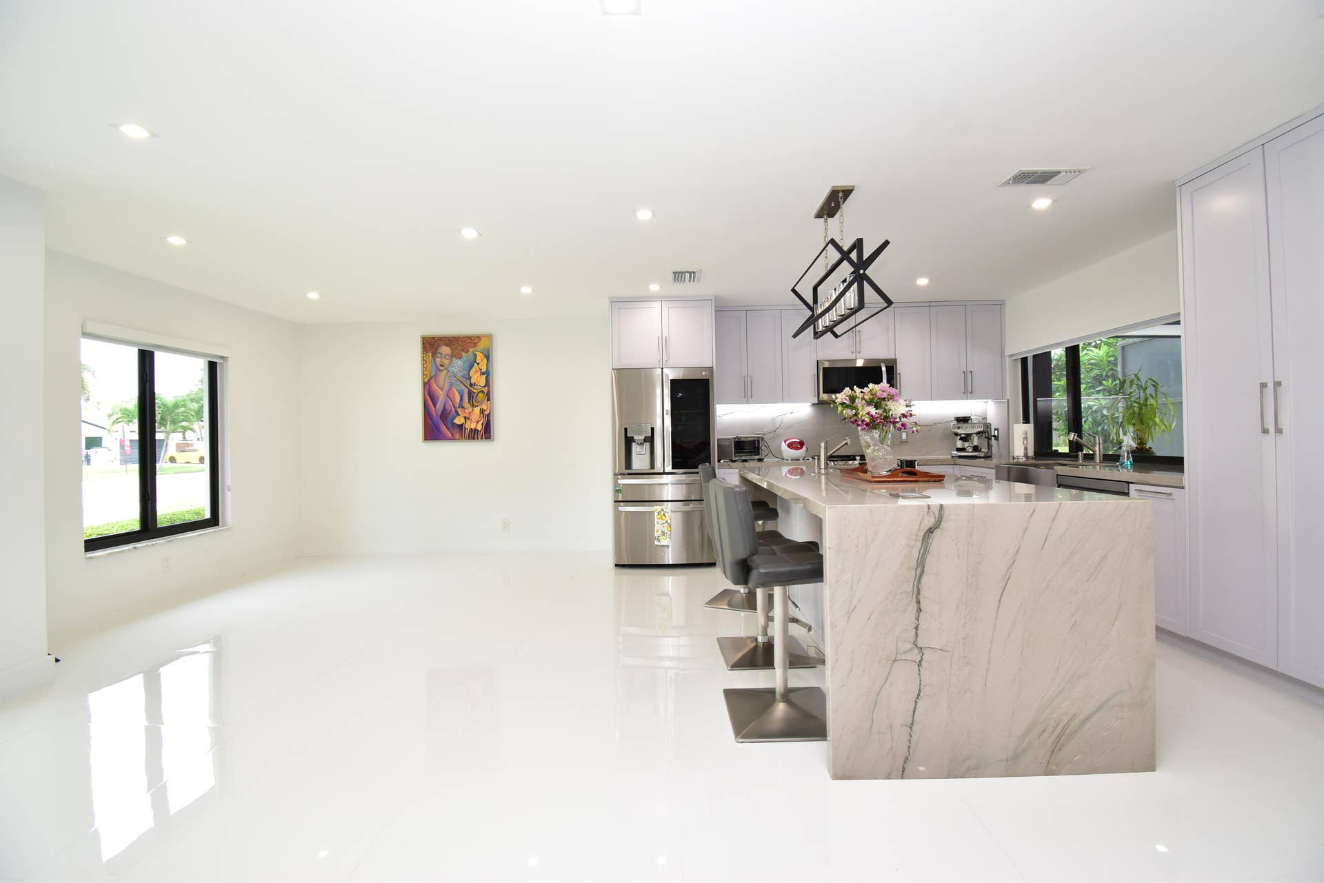 5061 SW 87TH Terrace, Cooper City, FL 33328 Open-concept living space featuring a gourmet kitchen with a waterfall island, stainless steel appliances, recessed lighting, and expansive windows