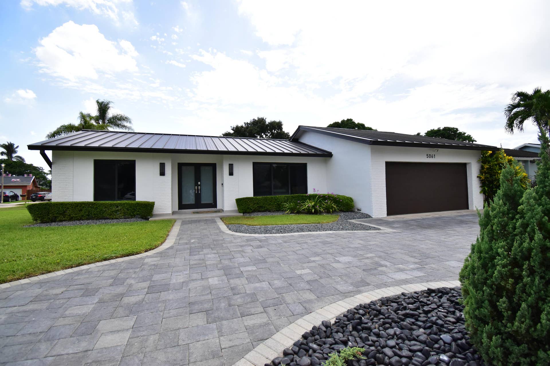 5061 SW 87TH Terrace, Cooper City, FL 33328 Contemporary white stucco exterior with a dark metal roof