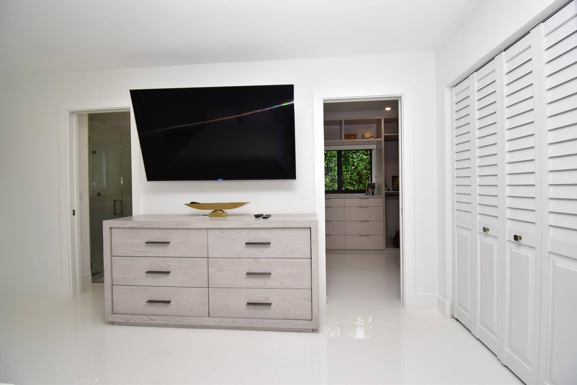 5061 SW 87TH Terrace, Cooper City, FL 33328 White flooring throughout, featuring a wall-mounted television above a six-drawer dresser with dark hardware