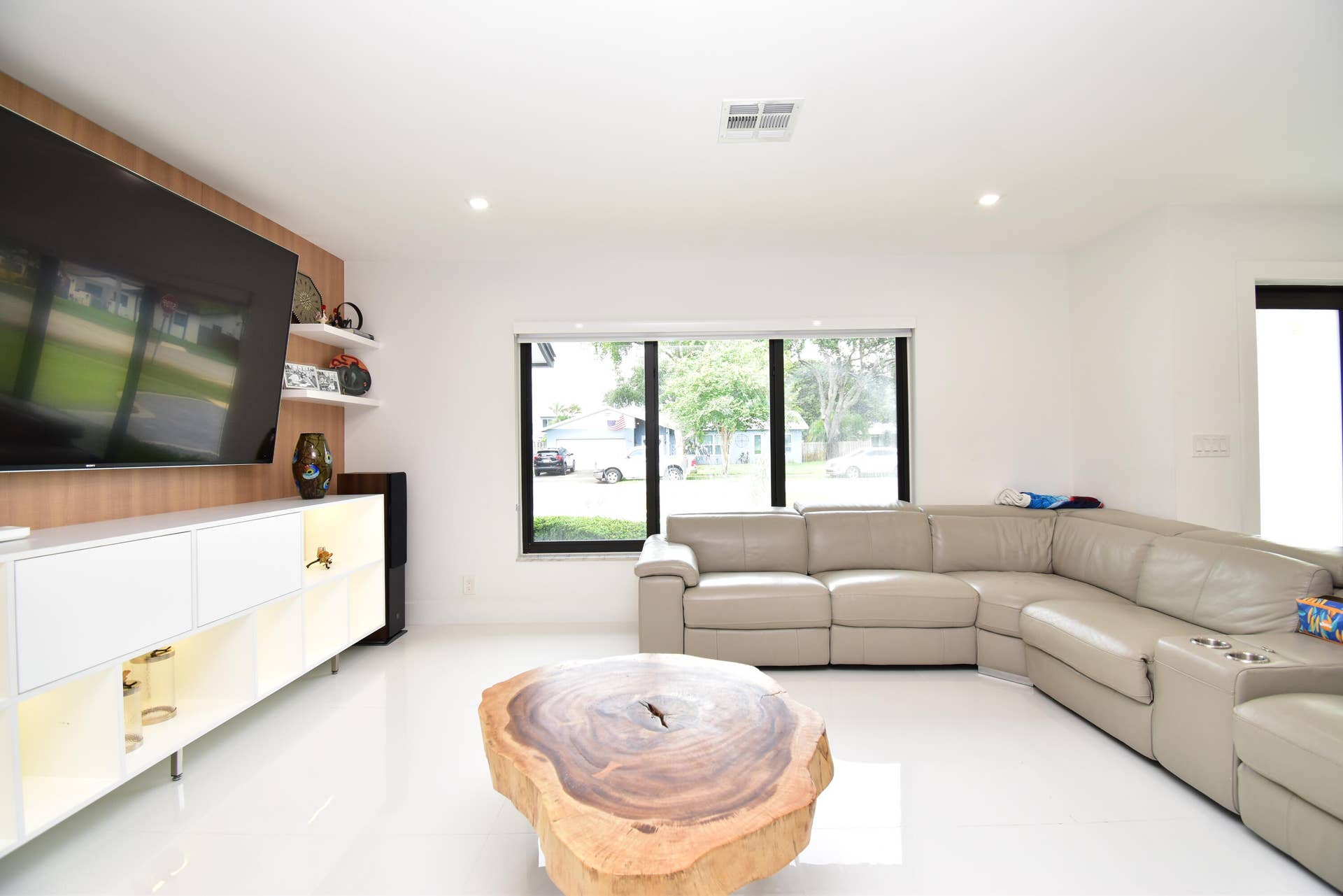 5061 SW 87TH Terrace, Cooper City, FL 33328 Bright living area featuring recessed lighting, a large window with black framing, and a built-in media console with open and closed storage