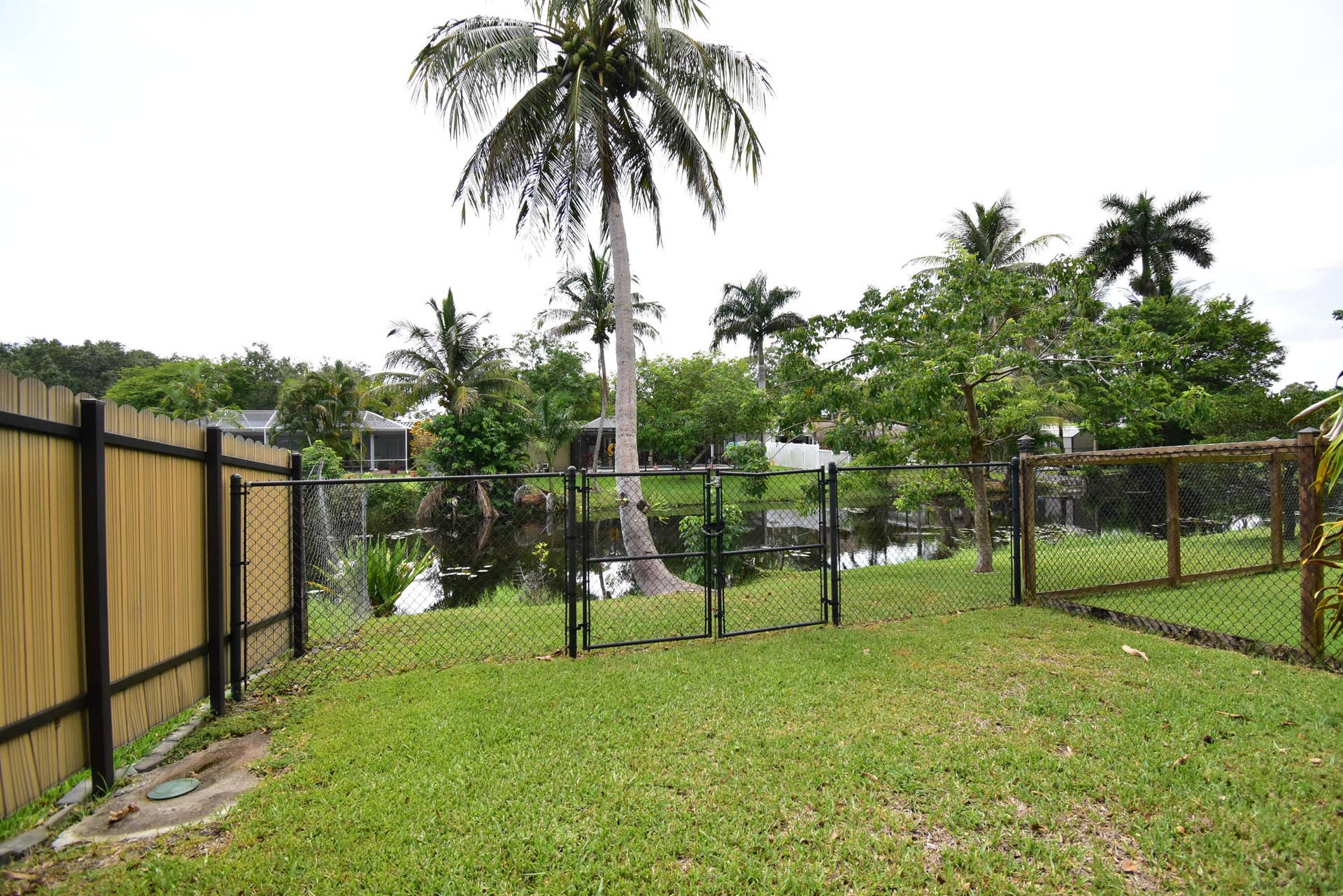 5061 SW 87TH Terrace, Cooper City, FL 33328 Expansive backyard featuring a manicured lawn, full fencing, and direct water access