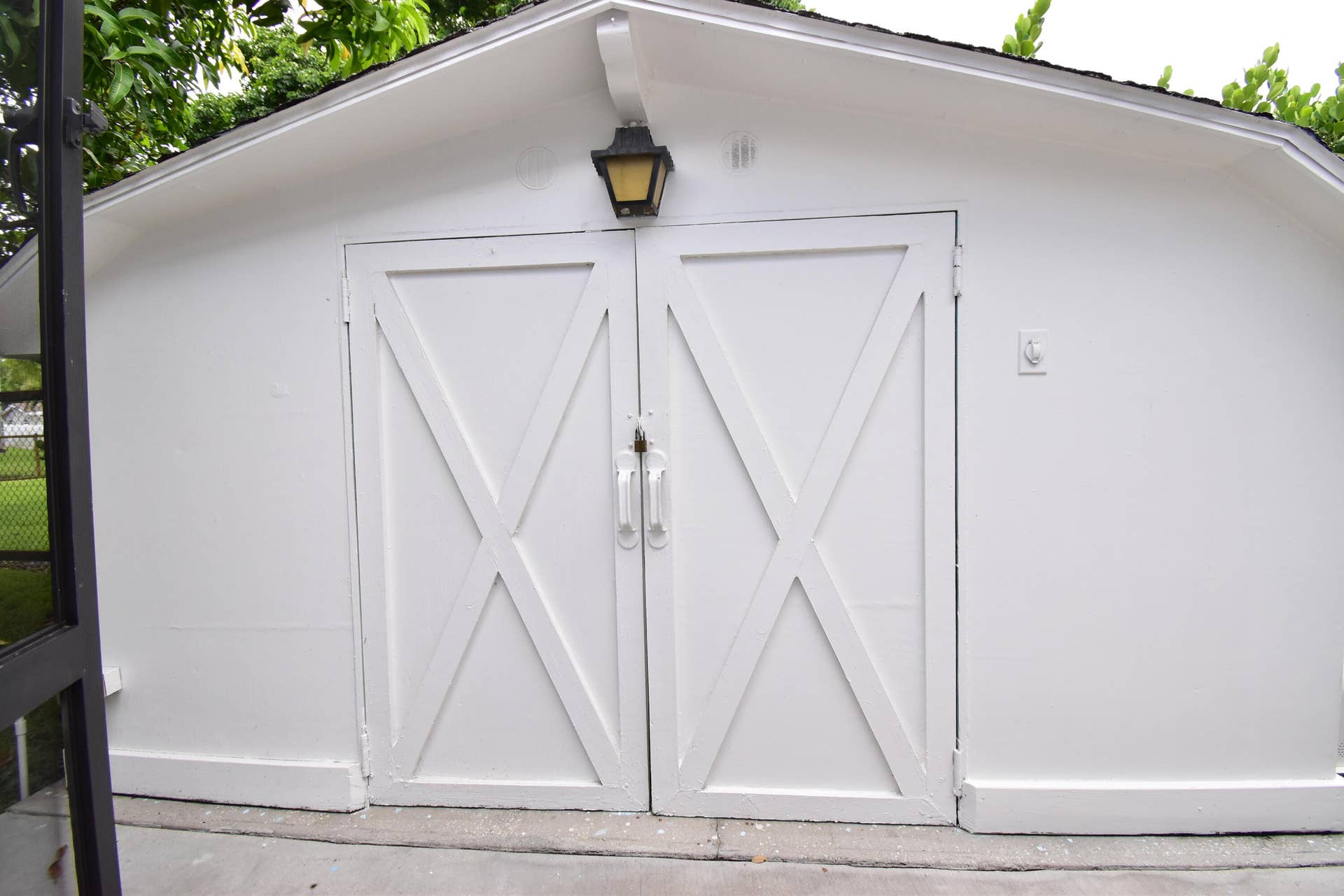 5061 SW 87TH Terrace, Cooper City, FL 33328 White utility structure featuring barn-style doors with decorative X-bracing
