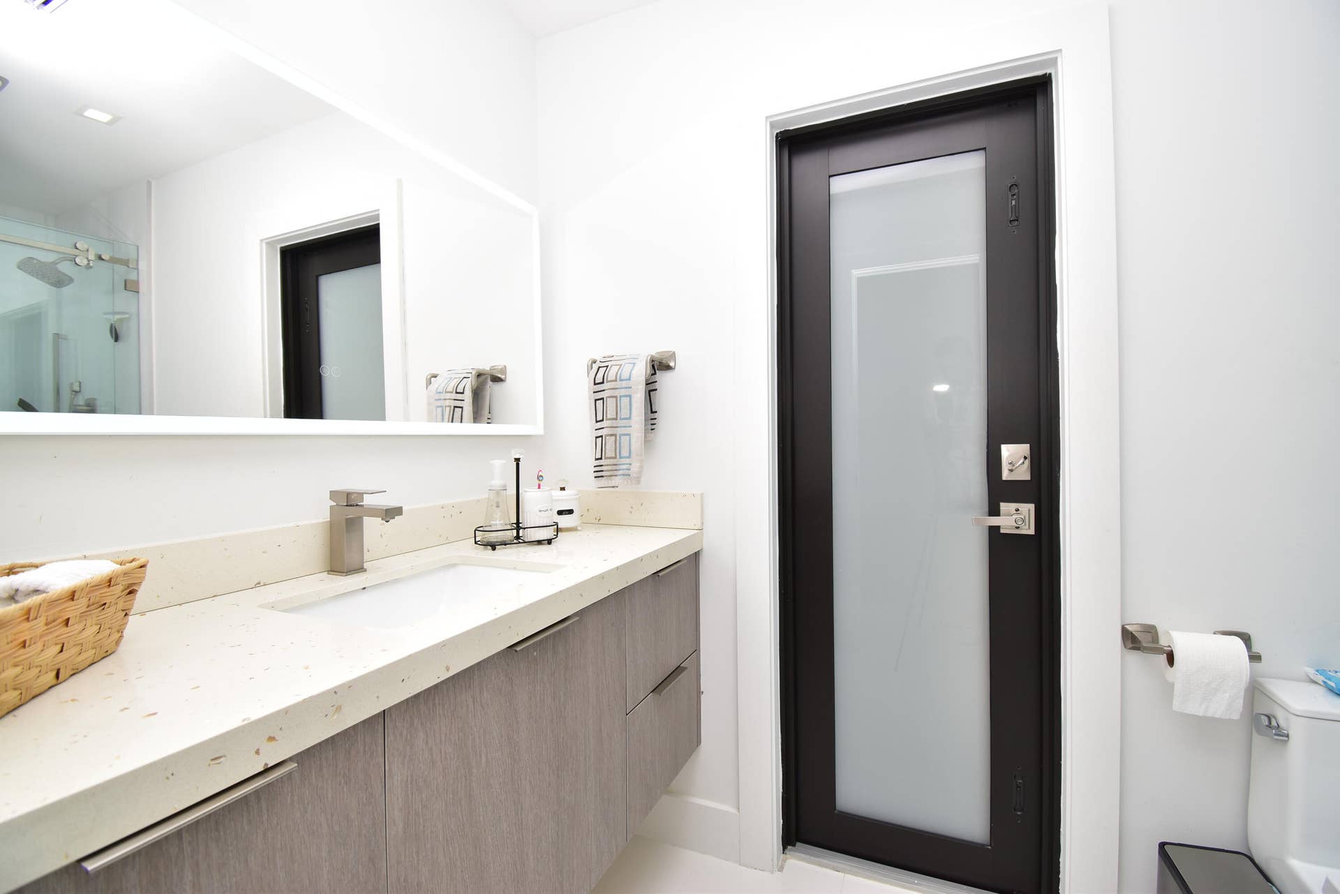 5061 SW 87TH Terrace, Cooper City, FL 33328 Bathroom vanity featuring a light-colored countertop with an undermount sink, brushed nickel faucet, and wood-finish cabinetry
