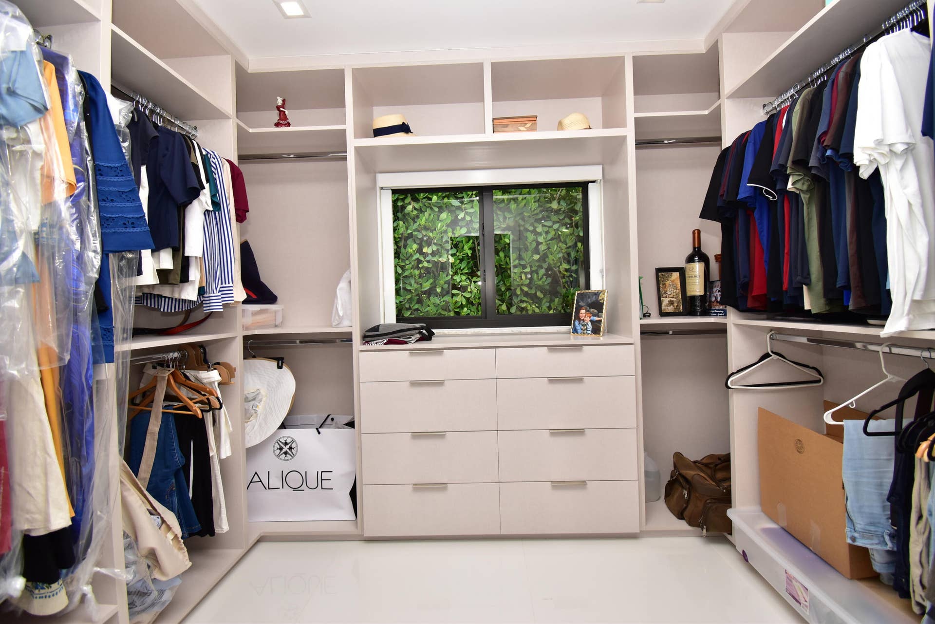 5061 SW 87TH Terrace, Cooper City, FL 33328 Custom closet system featuring built-in shelving, multiple hanging rods, and integrated drawer storage