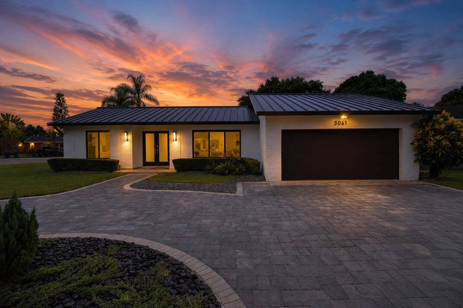 5061 SW 87TH Terrace, Cooper City, FL 33328 Modern single-story residence with a dark metal roof and white brick exterior