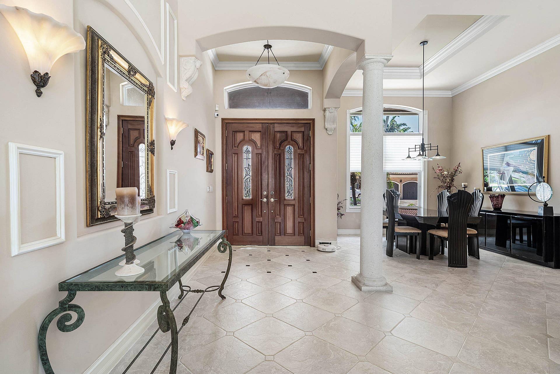 2761 NE 48TH Court, Lighthouse Point, FL 33064 Grand entryway featuring double wood-paneled doors with etched glass, arched doorways, and a decorative column