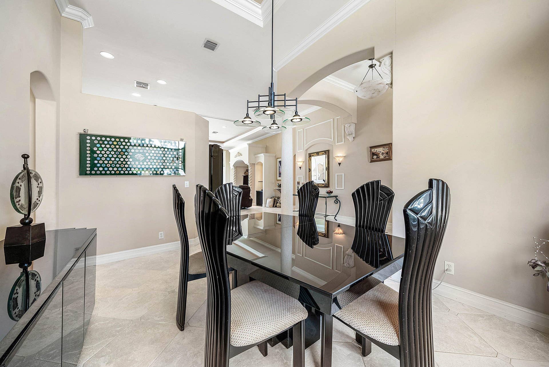 2761 NE 48TH Court, Lighthouse Point, FL 33064 Formal dining area featuring a modern chandelier, recessed lighting, crown molding, and tiled flooring