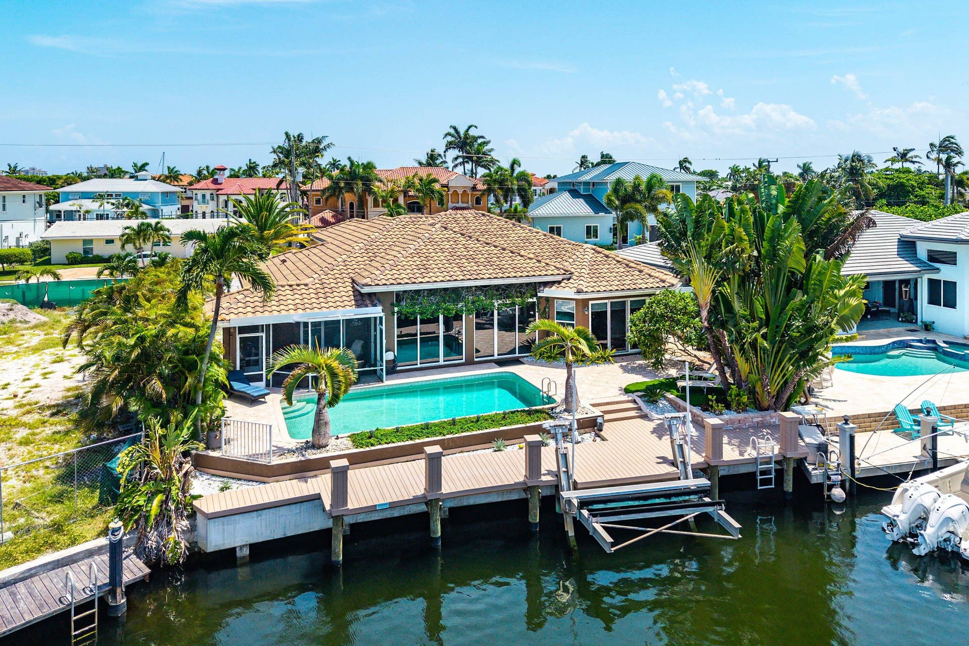 2761 NE 48TH Court, Lighthouse Point, FL 33064 Waterfront property featuring a private pool, new boat dock with boat lift, and direct ocean and intracoastal access just minutes from the Hillsboro Inlet.