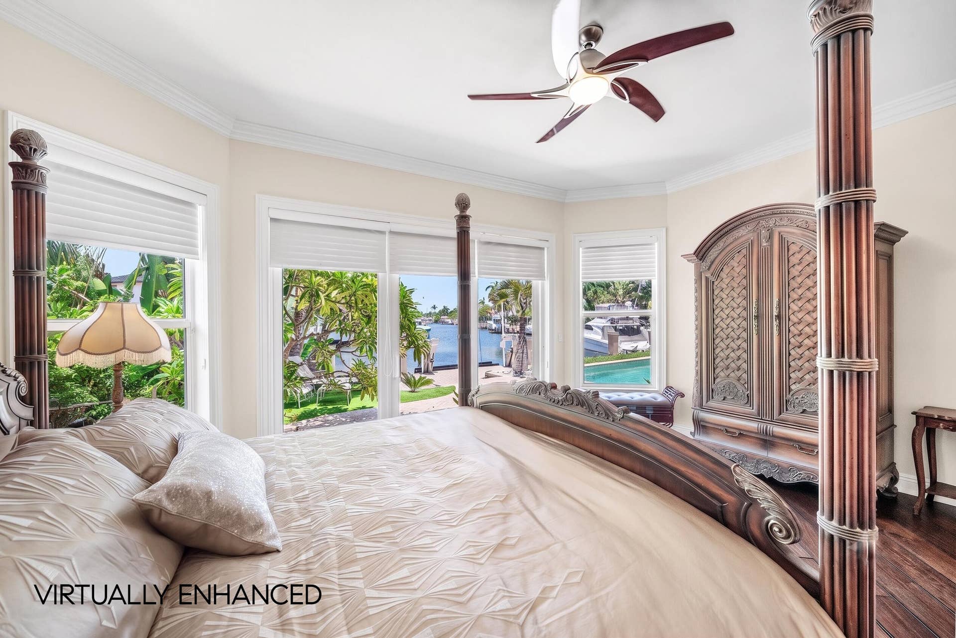 2761 NE 48TH Court, Lighthouse Point, FL 33064 Bay window with waterfront scenery, crown molding, ceiling fan, and wood-finish flooring
