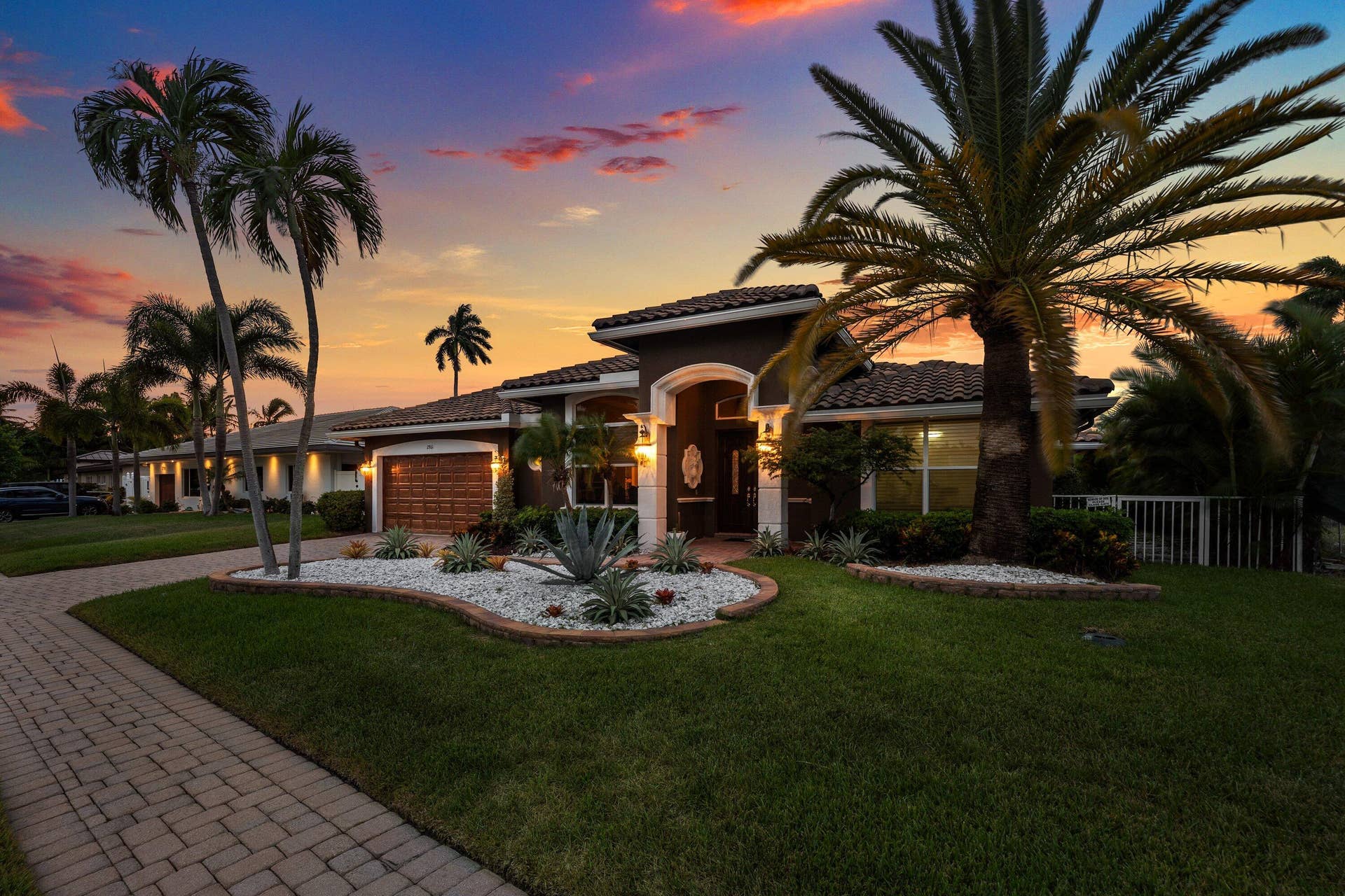 2761 NE 48TH Court, Lighthouse Point, FL 33064 Contemporary stucco exterior with a tile roof and wood-finish garage door