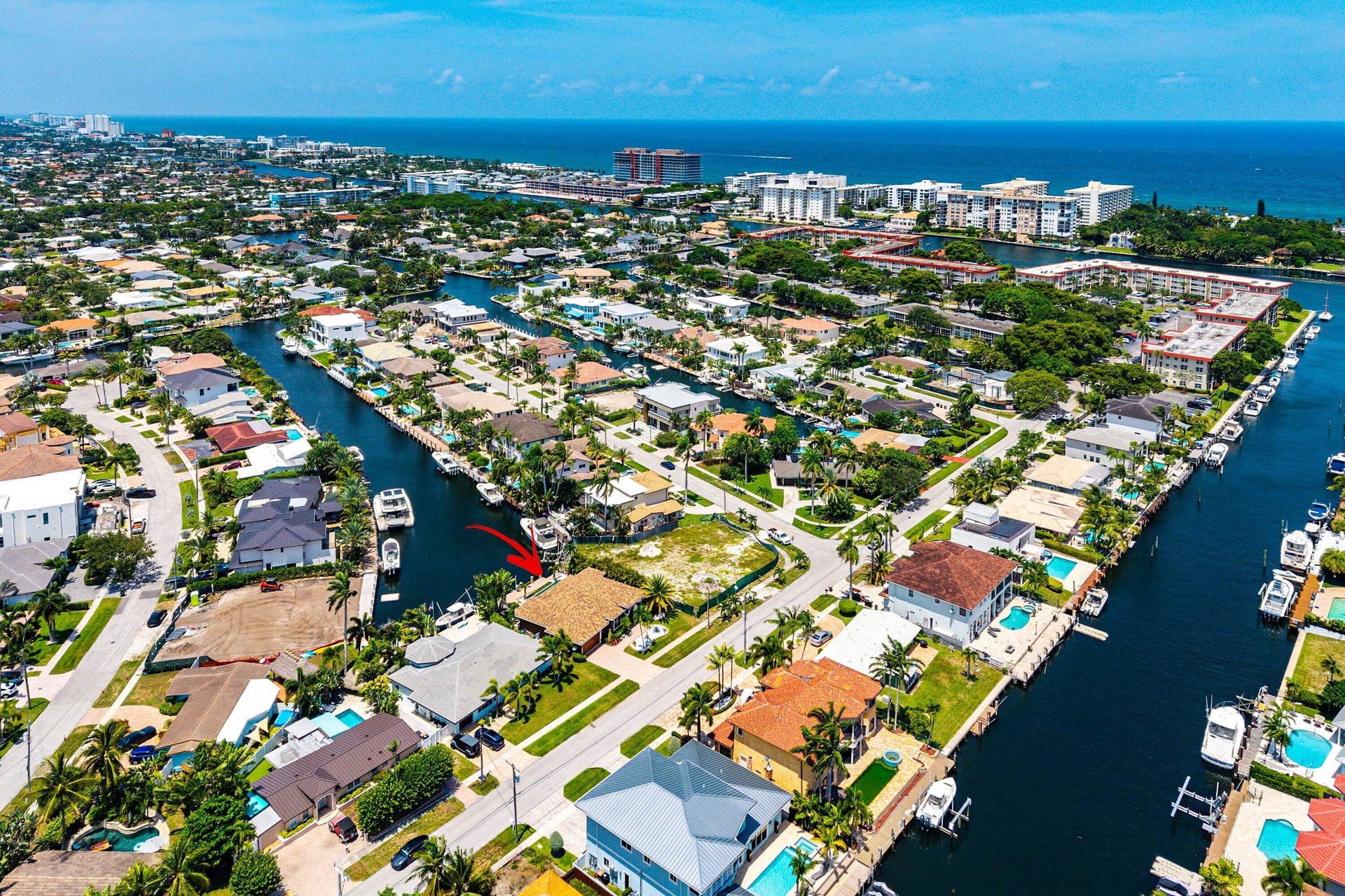 2761 NE 48TH Court, Lighthouse Point, FL 33064 Waterfront property featuring direct canal access, a private dock, mature landscaping, and proximity to coastal waters