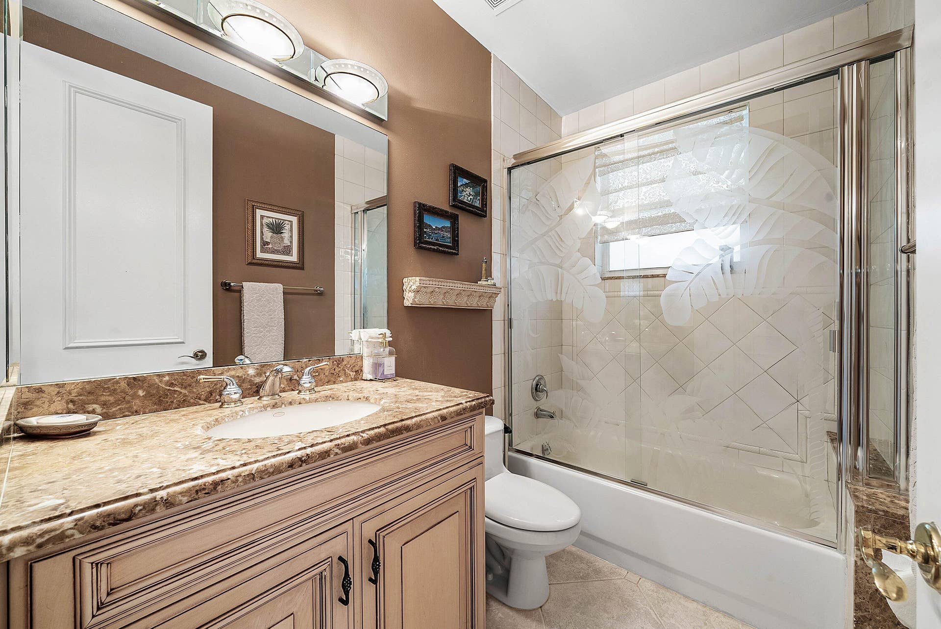 2761 NE 48TH Court, Lighthouse Point, FL 33064 Guest bathroom featuring a vanity with a stone-finish countertop and an integrated sink, illuminated by a vanity light fixture