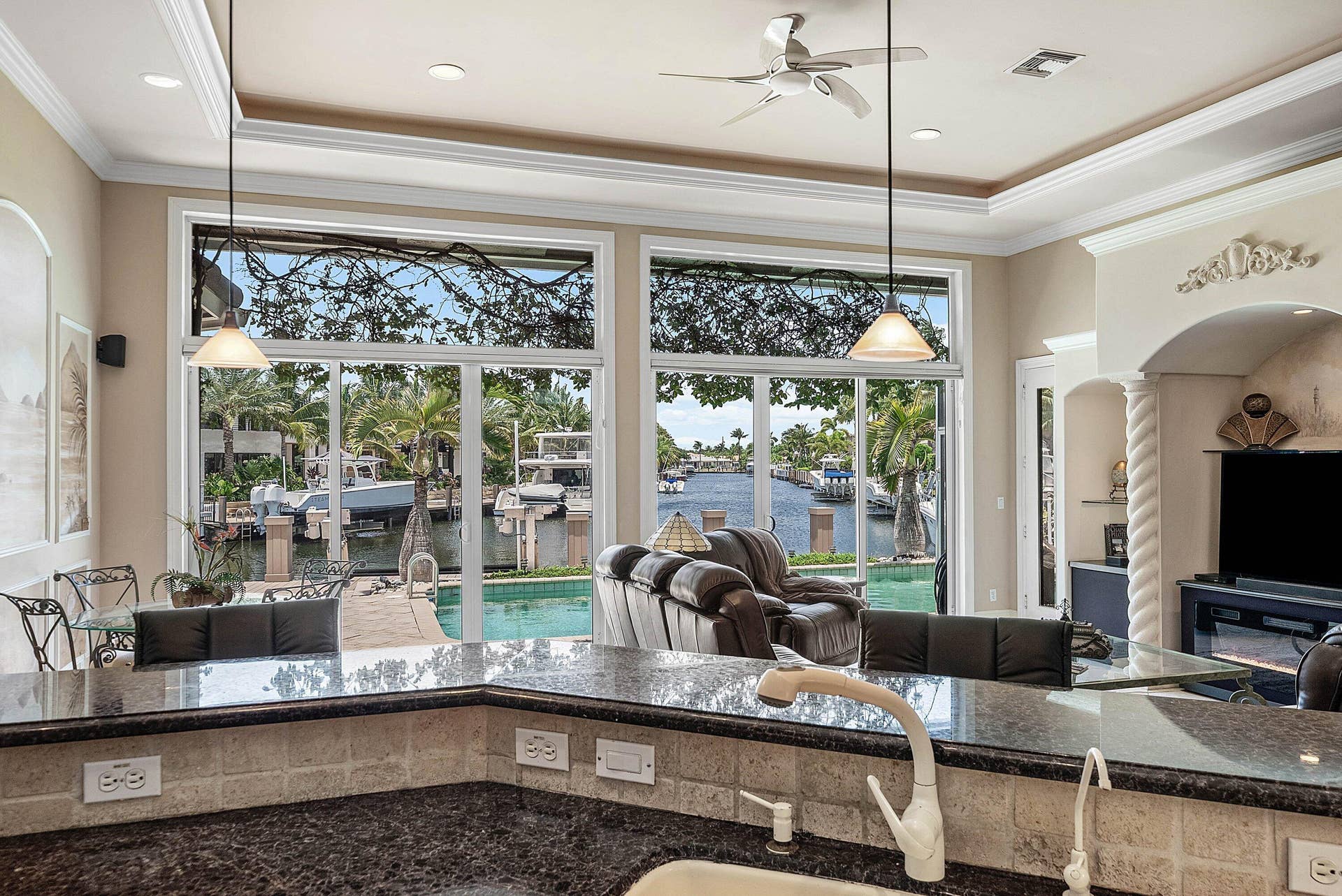 2761 NE 48TH Court, Lighthouse Point, FL 33064 Gourmet kitchen featuring dark granite countertops, neutral tile backsplash, and recessed lighting
