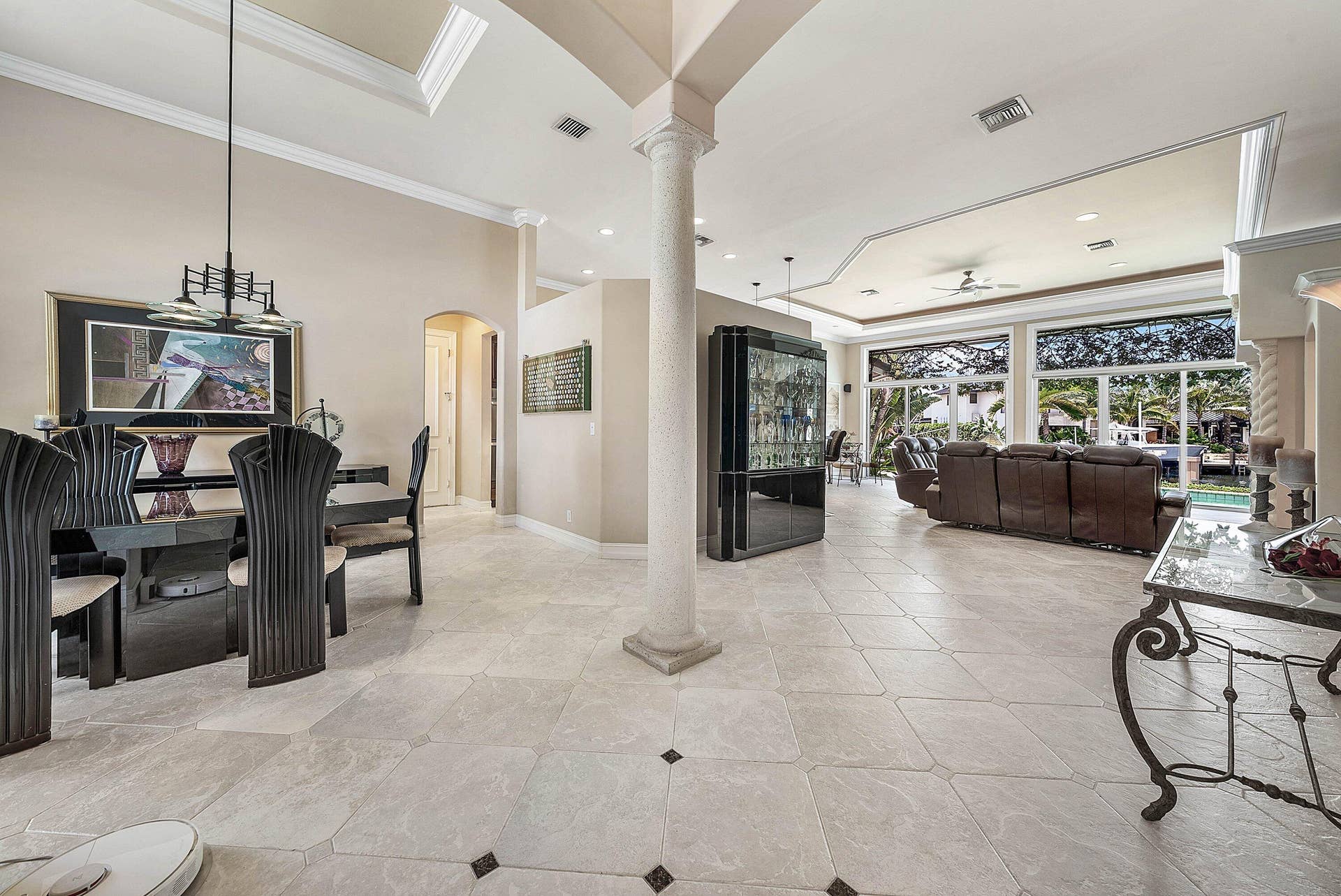 2761 NE 48TH Court, Lighthouse Point, FL 33064 Spacious interior with neutral wall tones and large format tile flooring featuring dark accent tiles