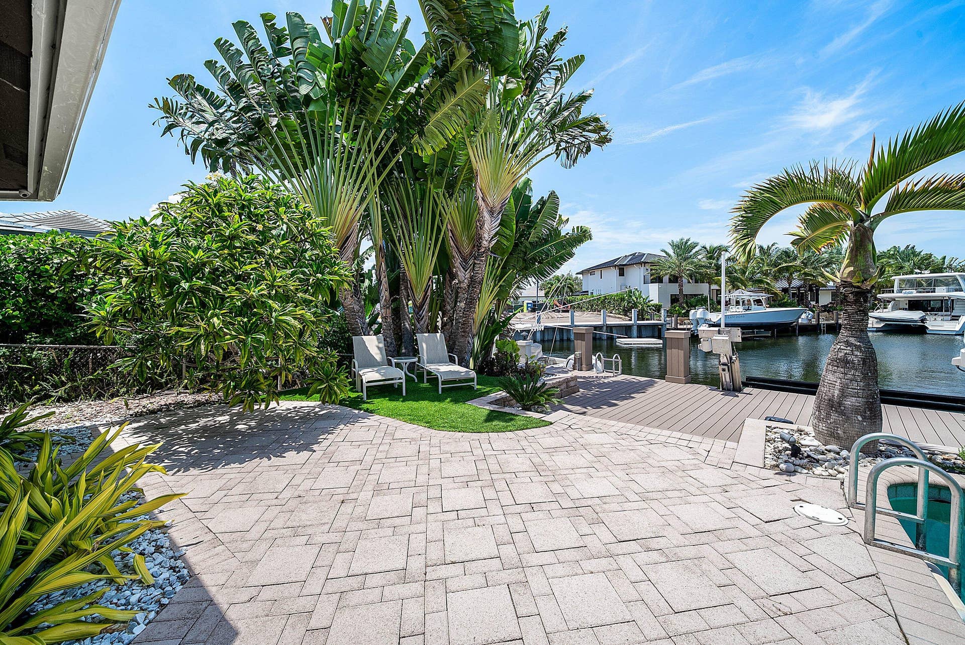 2761 NE 48TH Court, Lighthouse Point, FL 33064 Expansive outdoor living area featuring a patterned paver patio and direct canal access