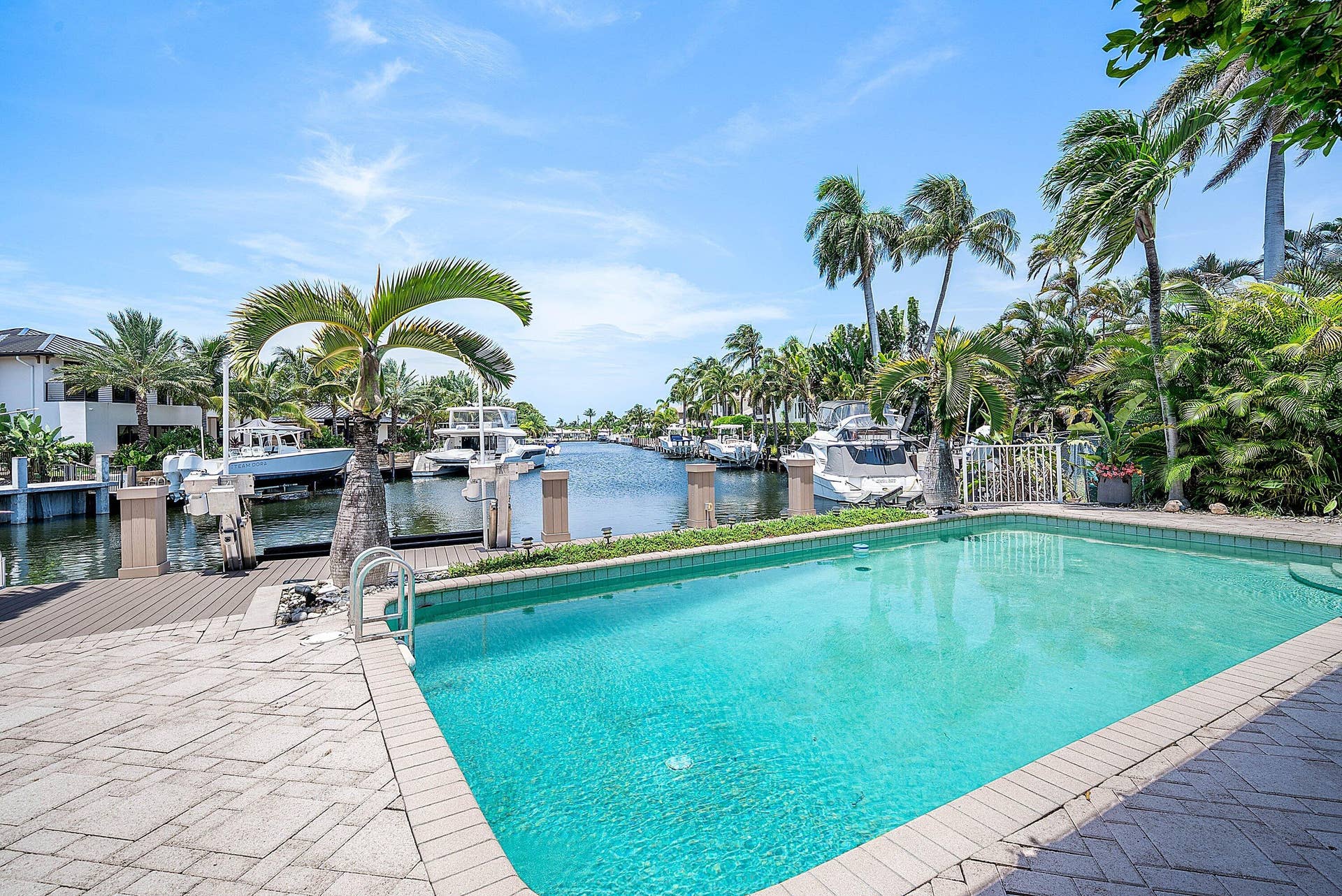 2761 NE 48TH Court, Lighthouse Point, FL 33064 Outdoor swimming pool with integrated steps, surrounded by paver patio