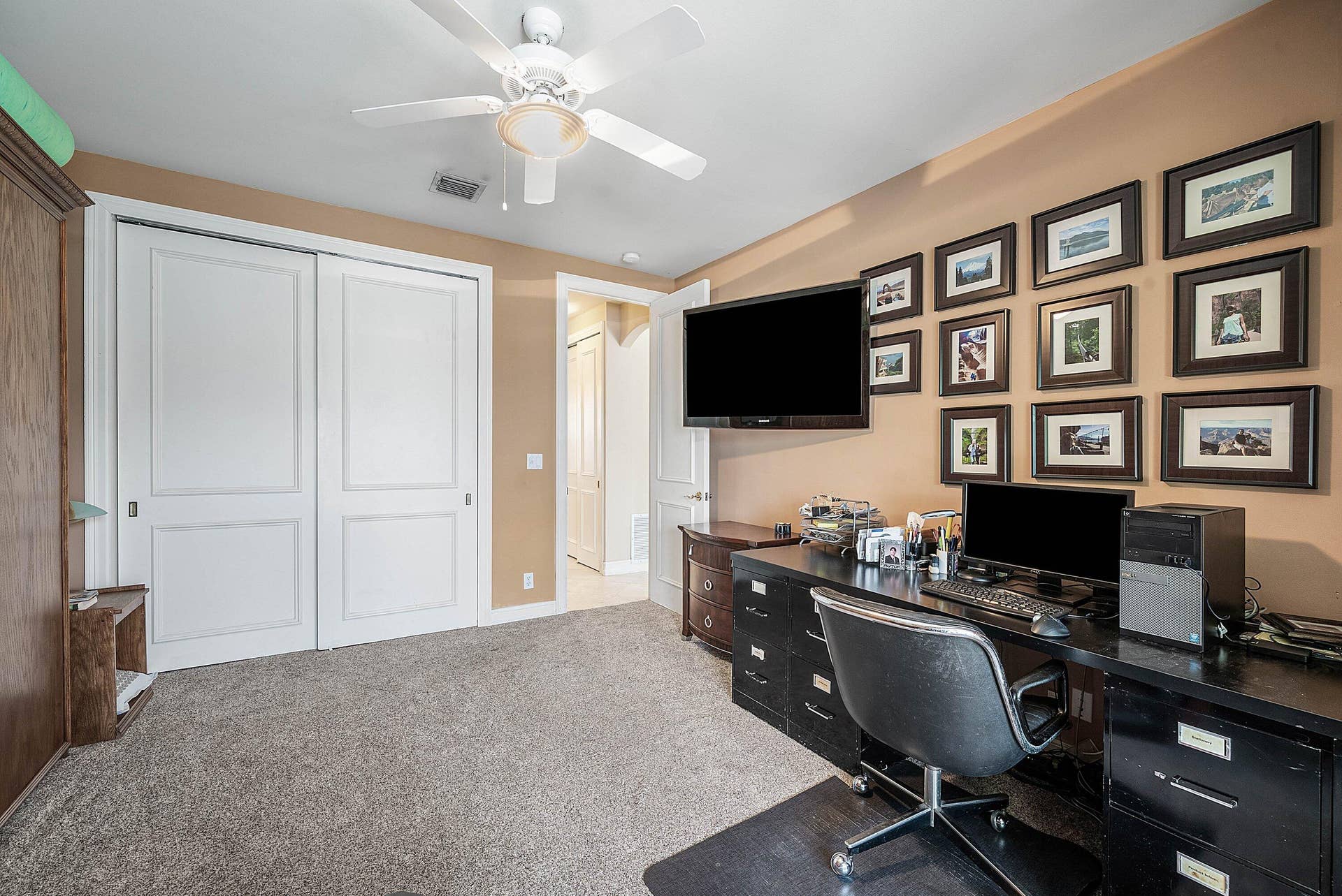 2761 NE 48TH Court, Lighthouse Point, FL 33064 Carpeted room featuring a ceiling fan, light tan walls, and white sliding closet doors