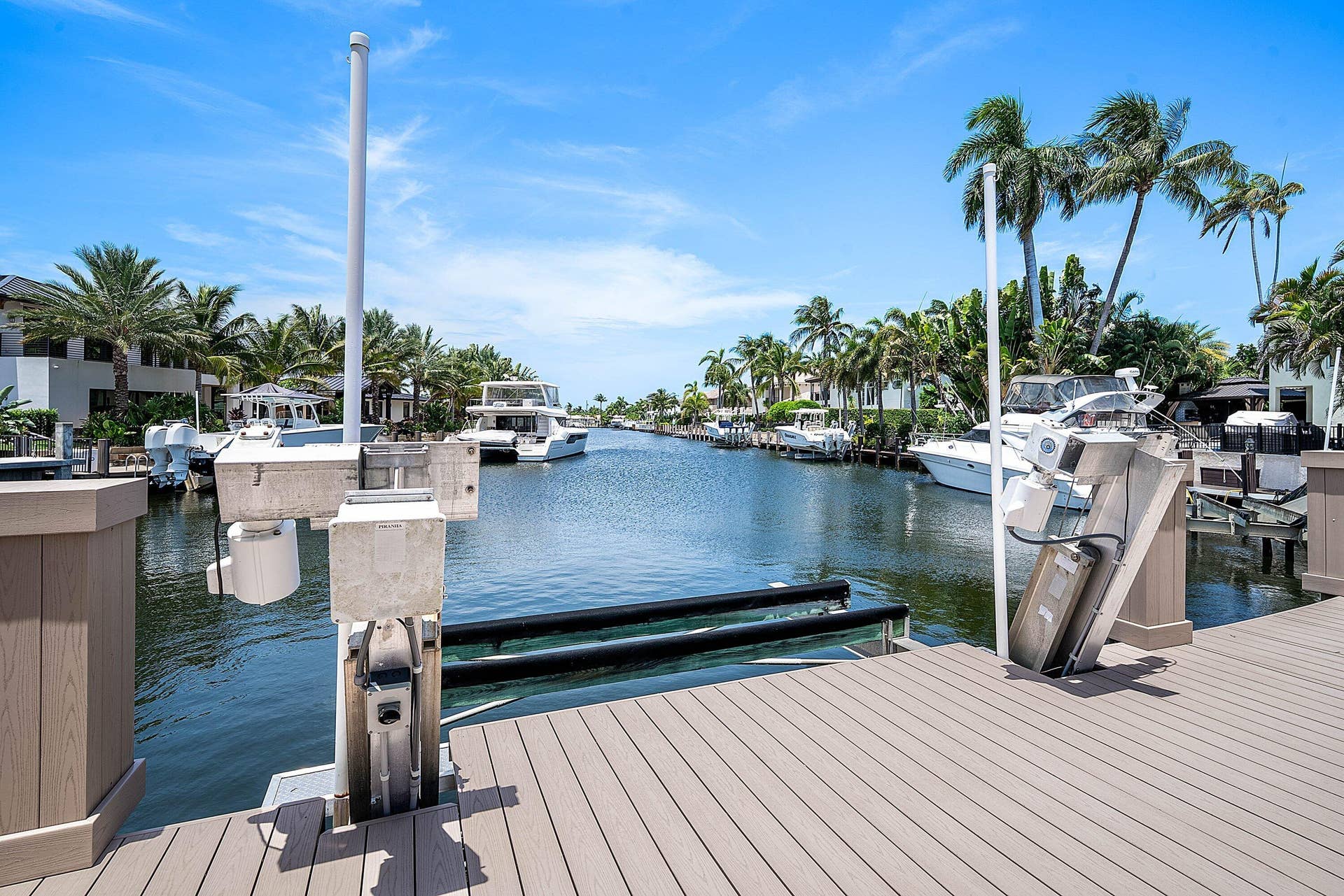 2761 NE 48TH Court, Lighthouse Point, FL 33064 Waterfront property featuring a private boat lift, composite decking, and canal access