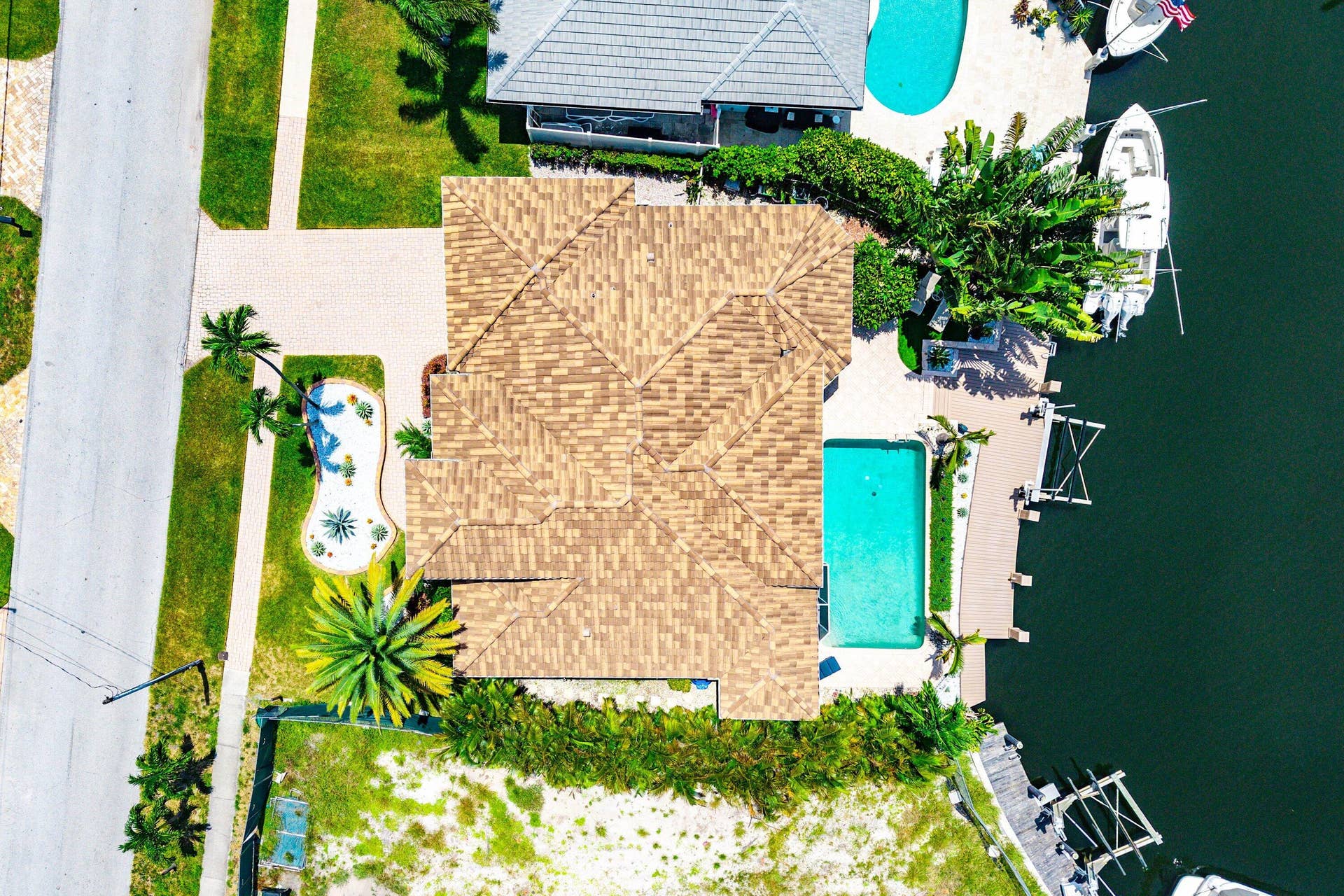 2761 NE 48TH Court, Lighthouse Point, FL 33064 Tile roof, rectangular swimming pool, paver patio, mature landscaping, and waterfront access with boat dockage