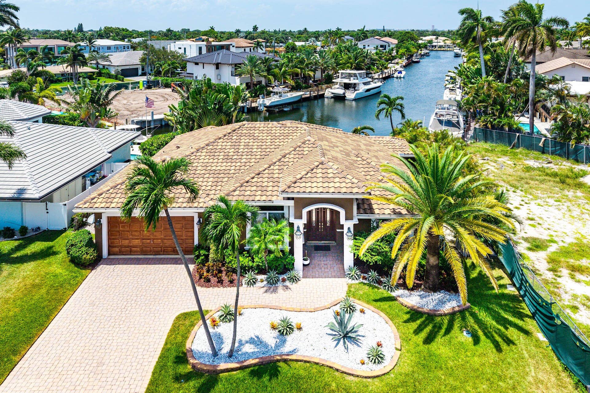 2761 NE 48TH Court, Lighthouse Point, FL 33064 Mediterranean-style residence featuring a tile roof and a paver driveway