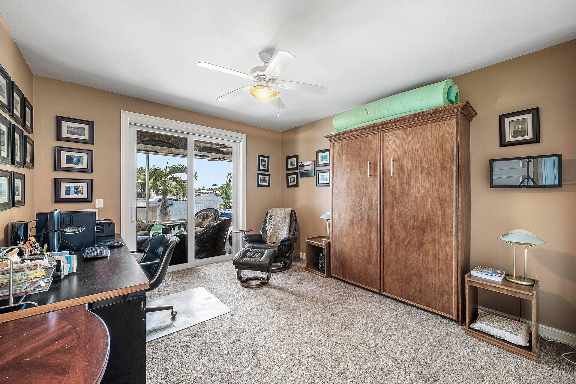 2761 NE 48TH Court, Lighthouse Point, FL 33064 Spacious interior featuring a large sliding glass door opening to a covered loggia overlooking the waterway