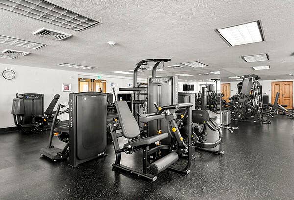 Gym adjacent to pool deck, sauna, steamroom & cabana baths